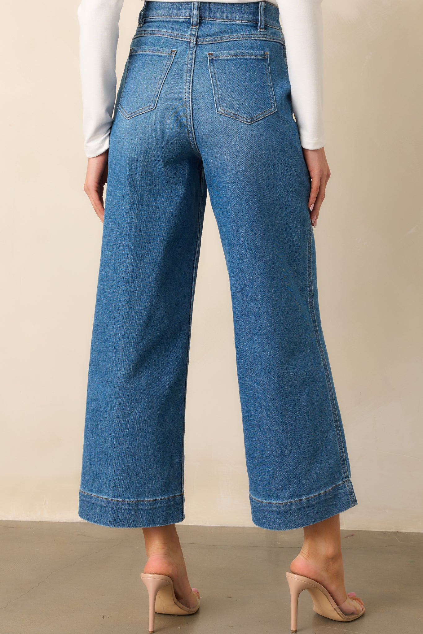 Rear view of the jeans showing the high-rise waistband and seamless, pocket-free back for a smooth finish.