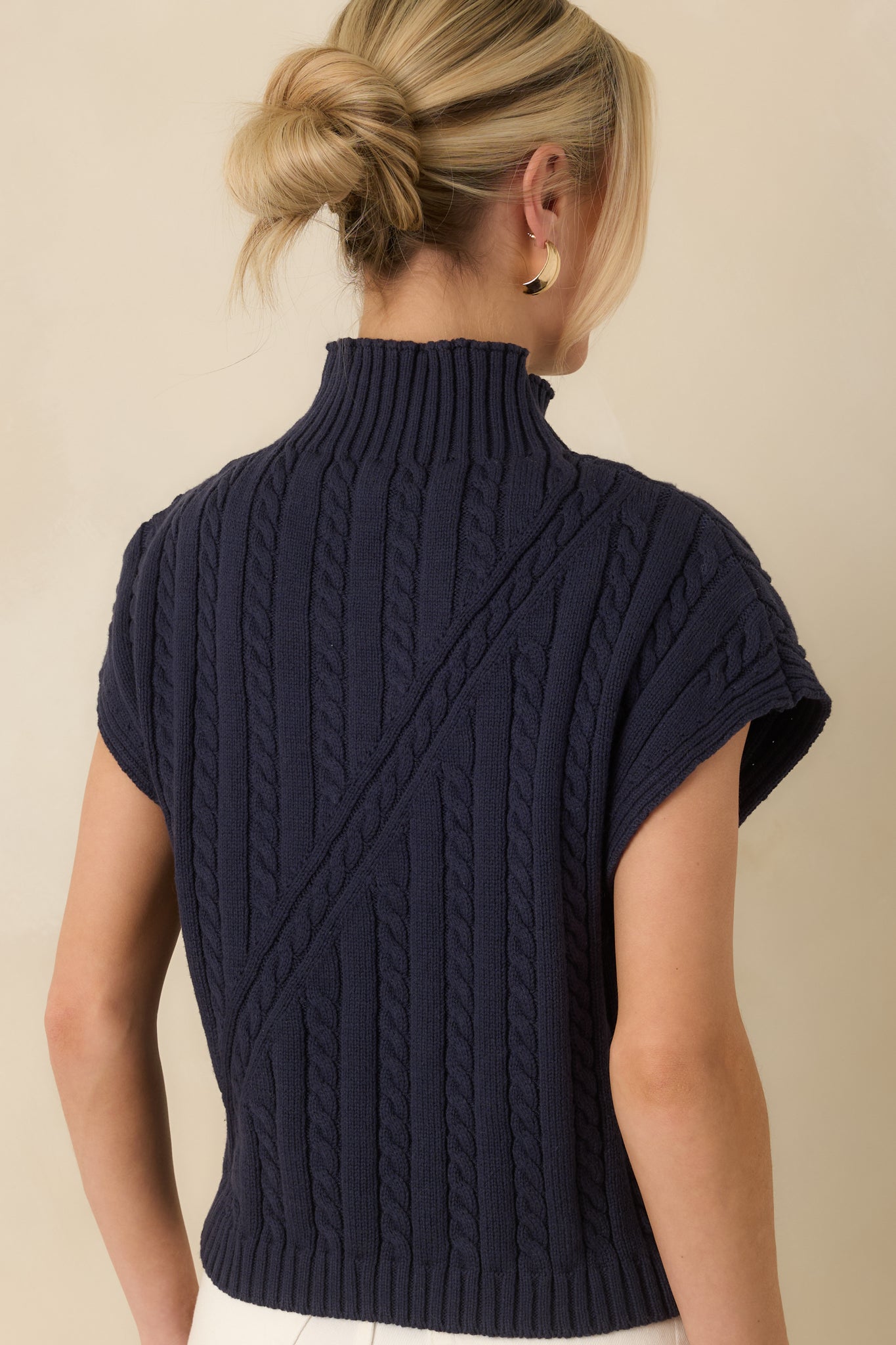 Rear view of the navy sleeveless cable knit sweater showing the smooth knit finish and relaxed silhouette.