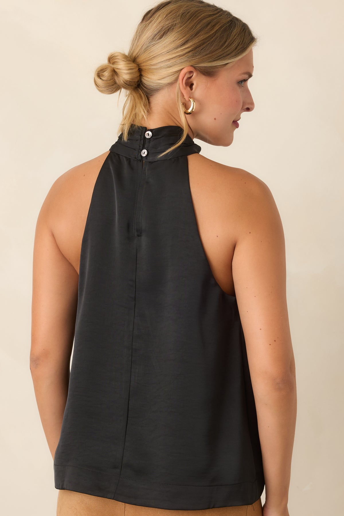 Rear view of the sleeveless halter top with a softly draped silhouette.