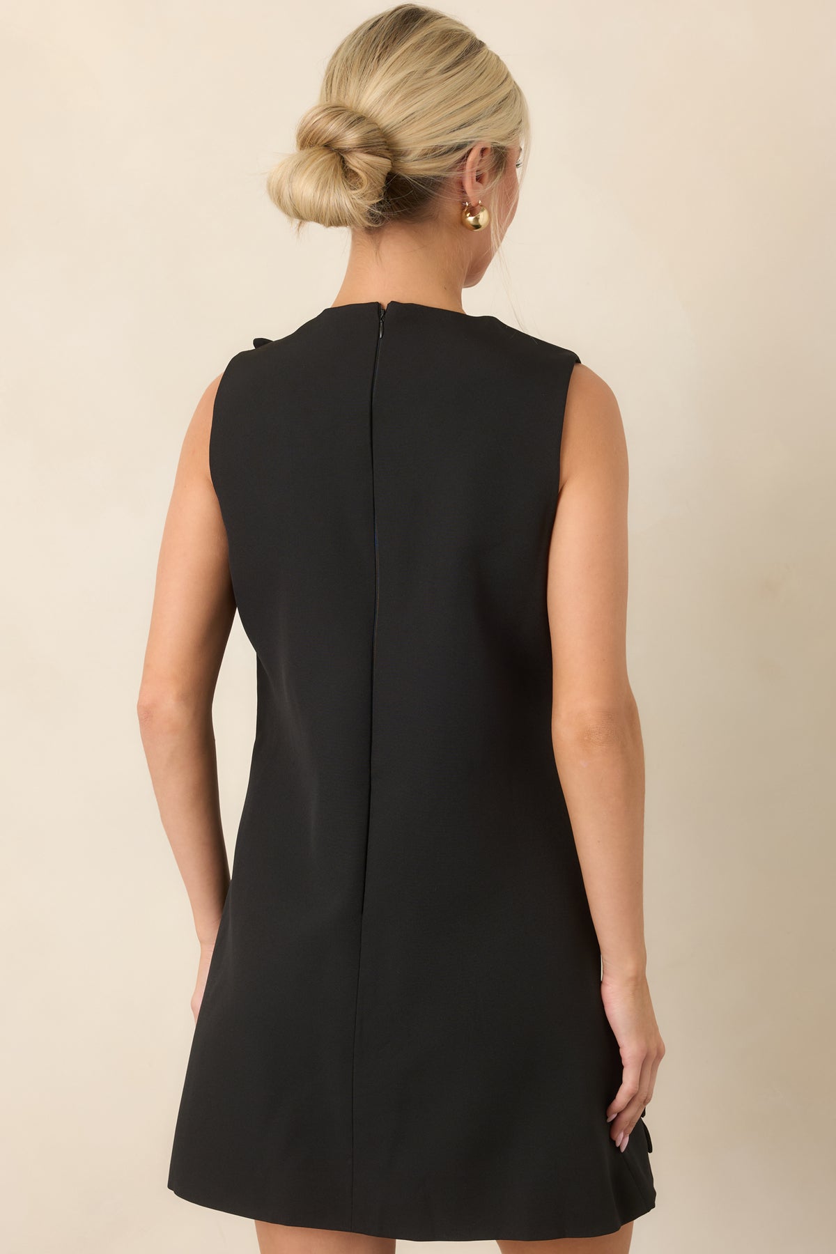 Rear view of the sleeveless mini dress showing the clean back and concealed zipper closure.