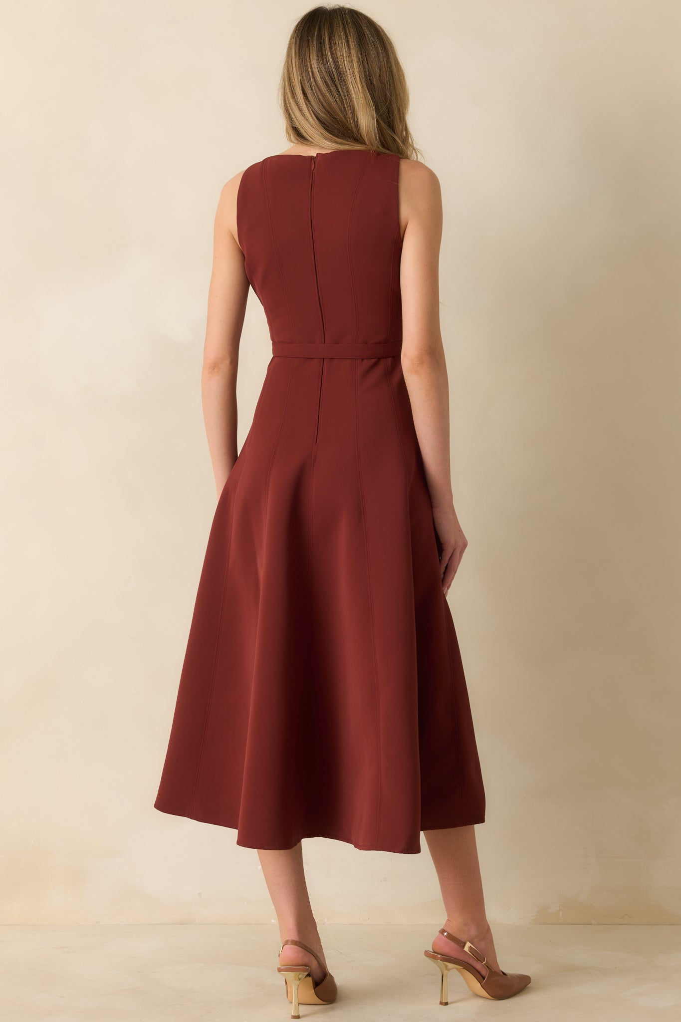Rear view of sleeveless wine red midi dress featuring concealed back zipper and flared A-line skirt.