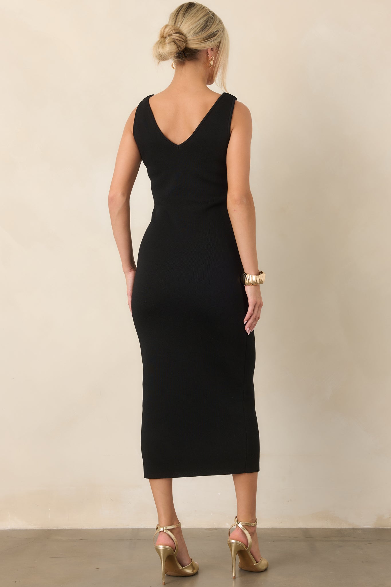 Rear view of the structured stretch-knit midi dress showcasing its smooth body-skimming silhouette and clean pullover construction.