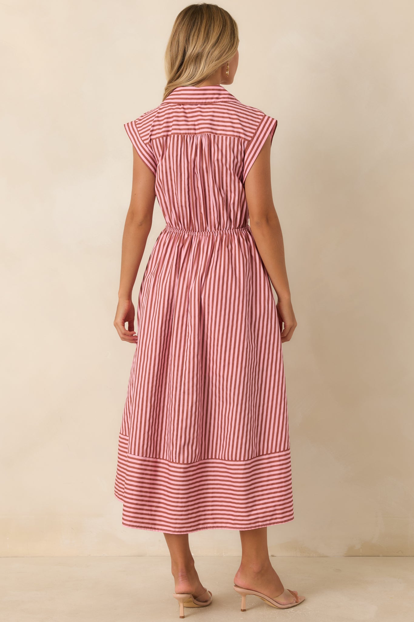 Rear view of the striped cotton midi dress featuring an elastic back waistband, tied waist detail, cap sleeves, and lined fabric.
