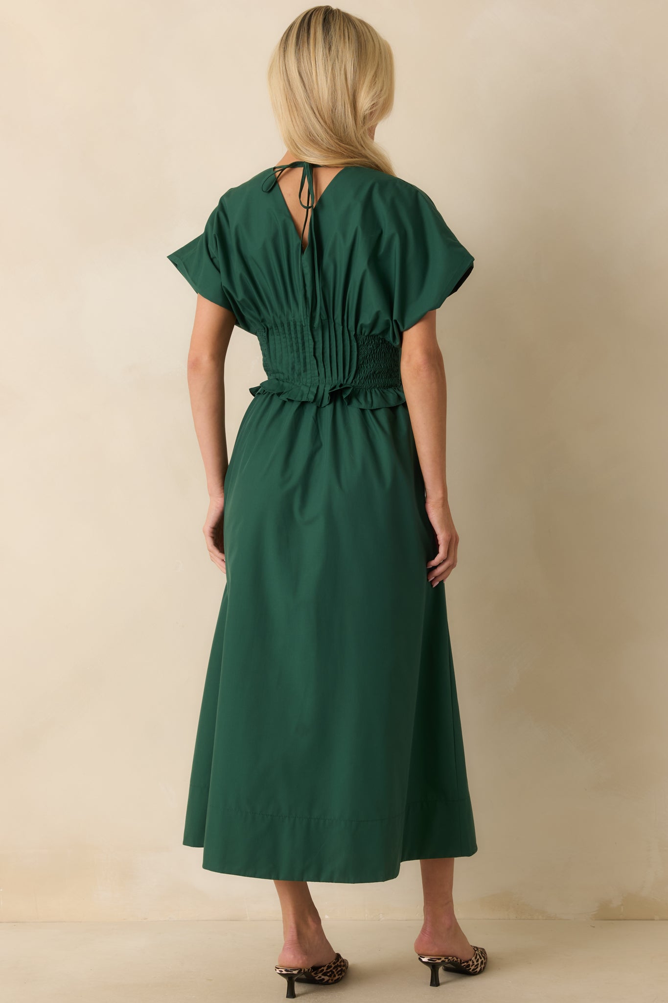Rear view of the woven maxi dress displaying the gathered waistband and relaxed drape of the skirt.