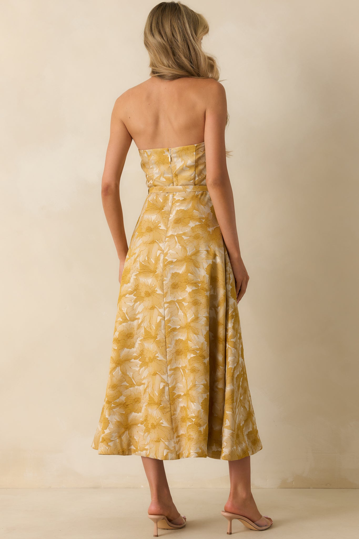 Rear view of the yellow gold dress showing hidden zipper closure and fitted bodice.