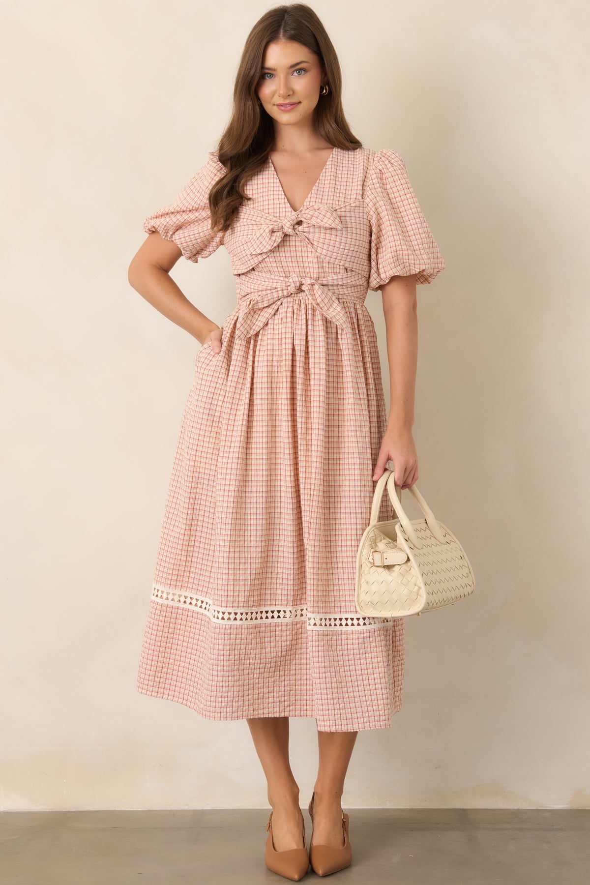 Red and beige plaid midi dress featuring a fitted bodice, puff sleeves, elastic waist, full skirt, and oversized double front ties.