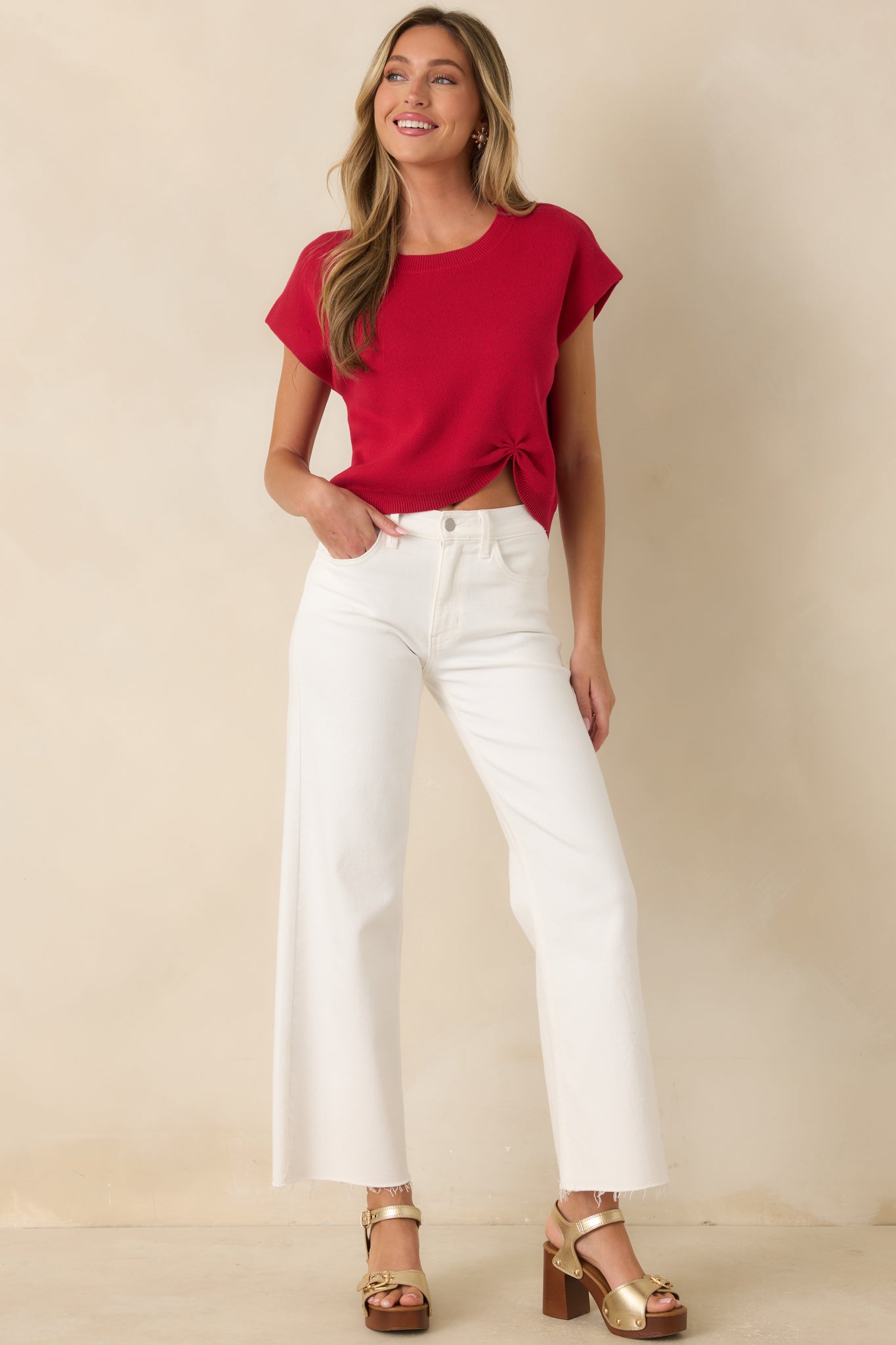 Red cotton-blend sweater designed with a lightweight feel, cap sleeves, and a flattering gathered front hem.