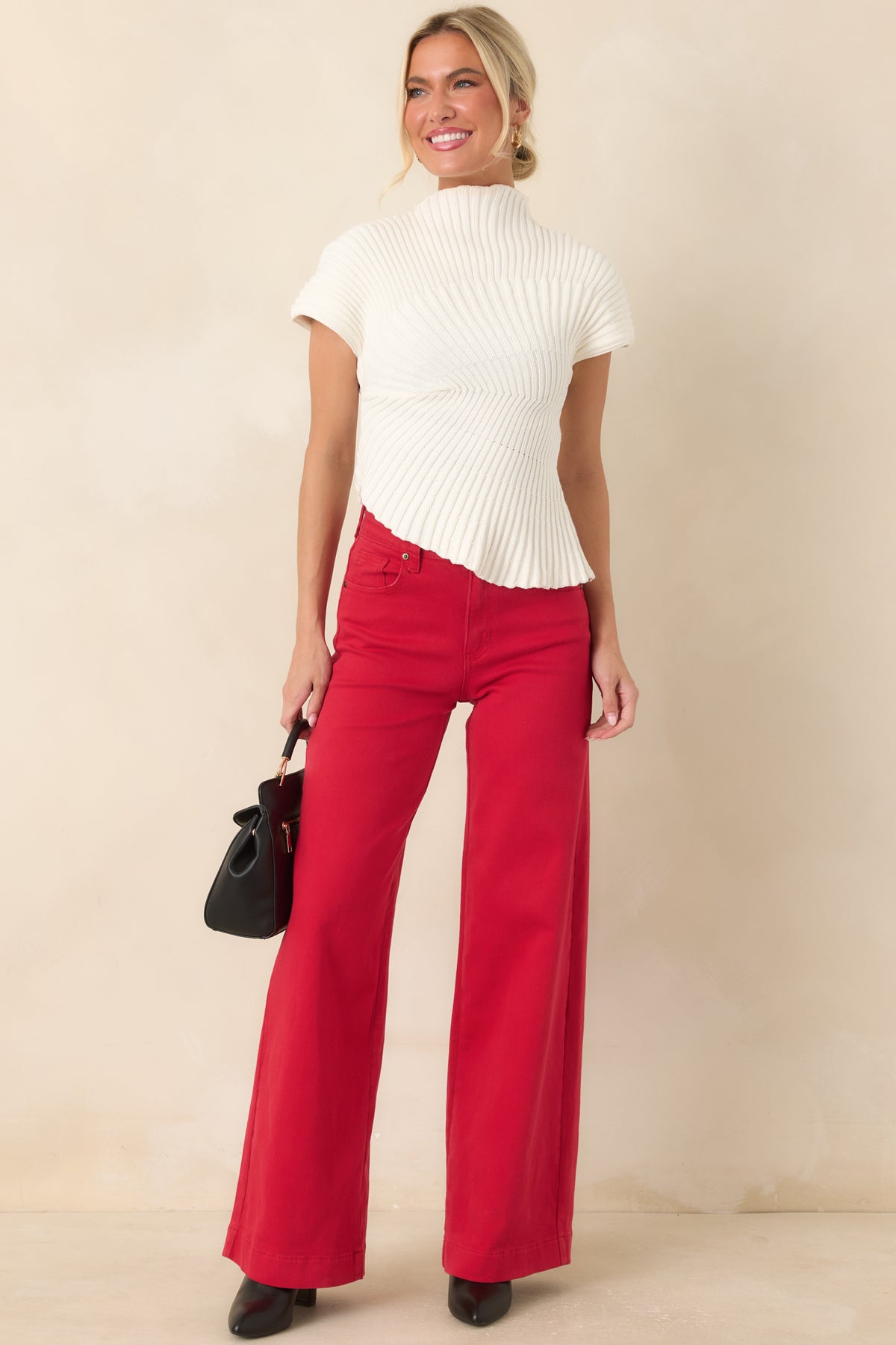 Red cotton-blend jeans featuring traditional five-pocket construction, belt loops, button-and-zip closure, and wide leg fit.