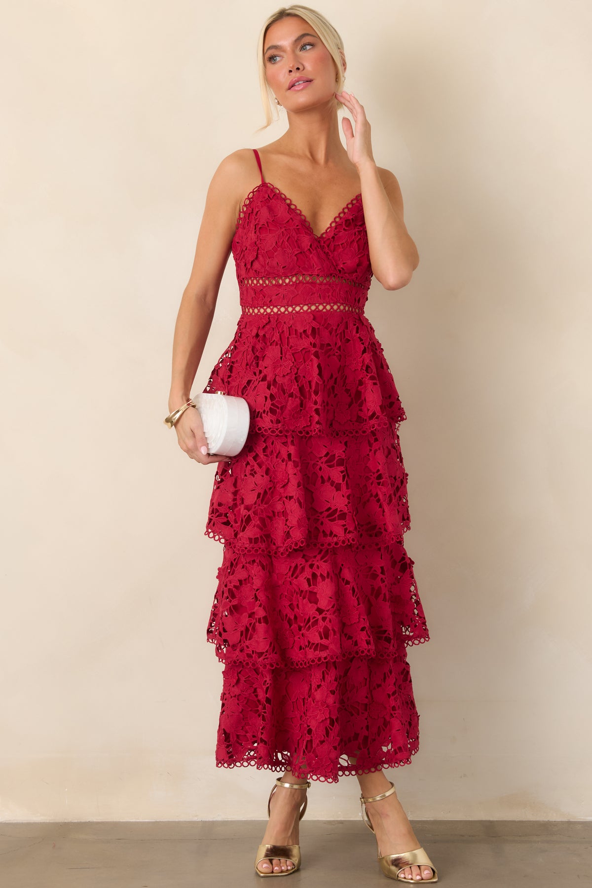 Floor-length red dress showcasing delicate floral lace tiers, a V-neckline, and open ladder-lace detailing at the waist.