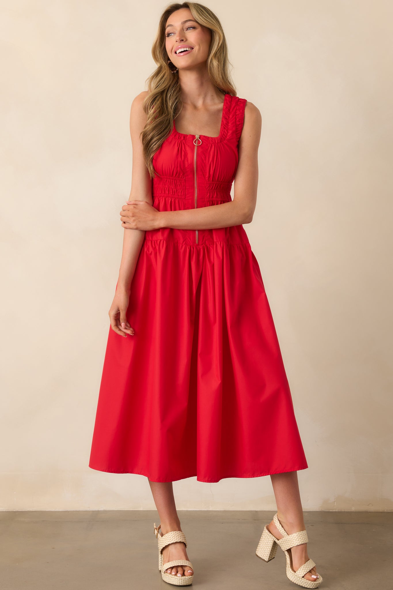Full body shot of a red dress featuring ruched trim detailing, scoop neck, and a structured but relaxed fit.