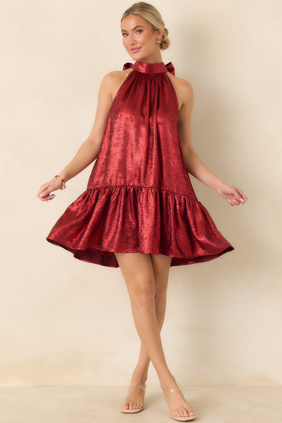 Red swing mini dress showcasing a gathered halter bodice, voluminous skirt, and playful ruffled hemline.