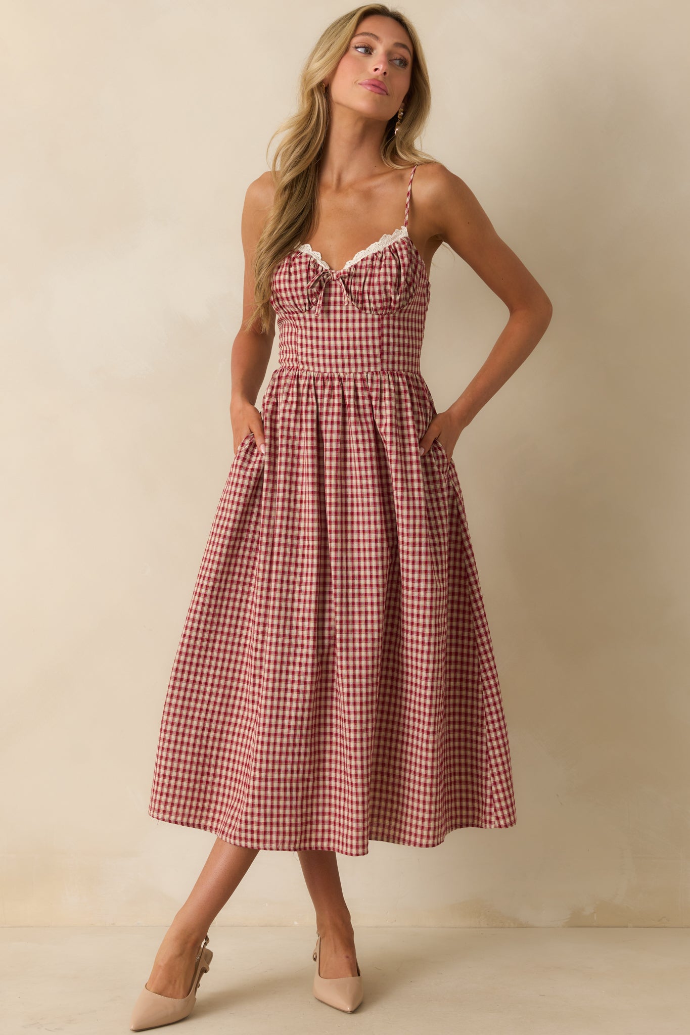 Red gingham midi dress with smocked back panel, structured bodice, and lace-trimmed neckline.
