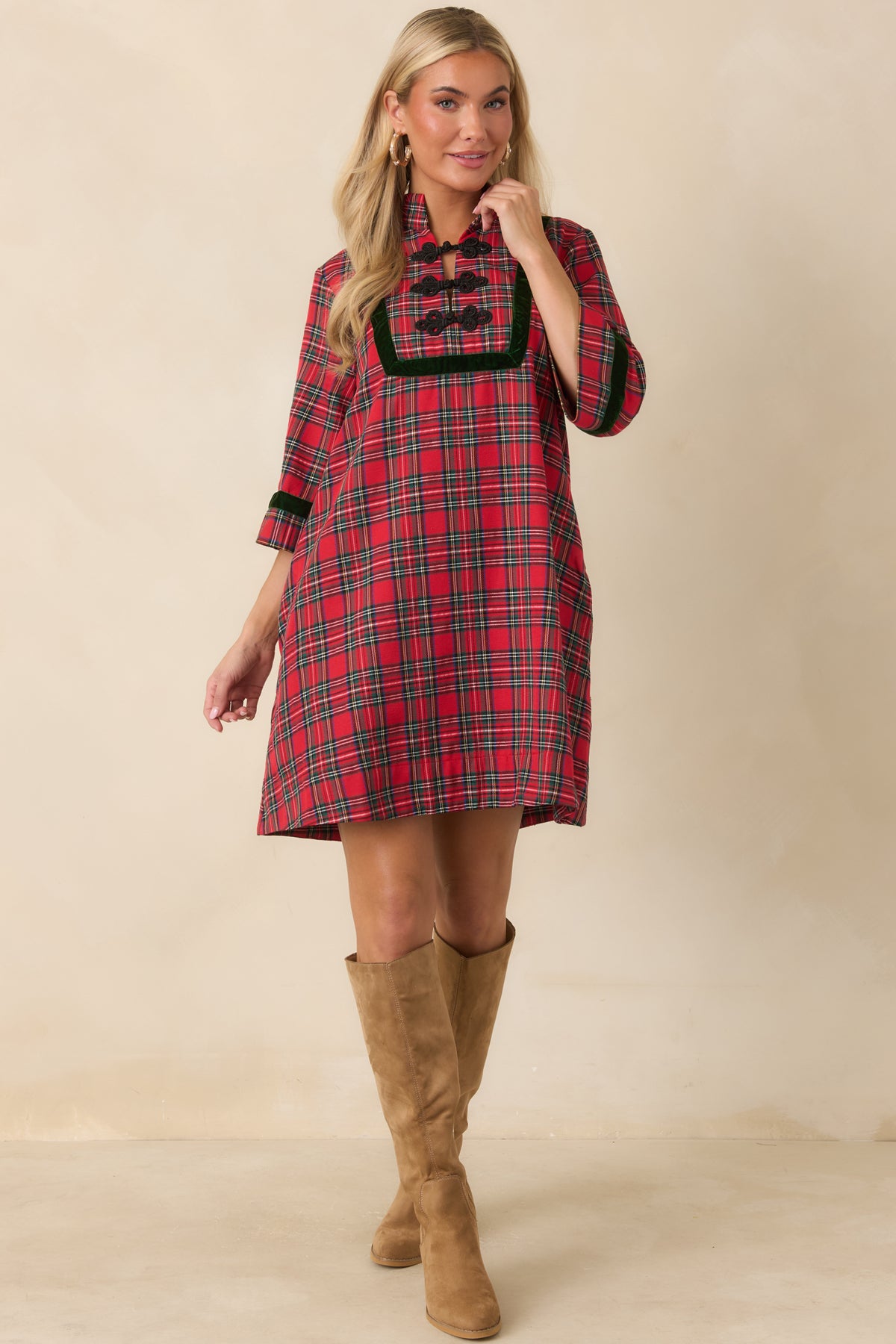 Red and green plaid dress with a structured stand collar, decorative black frog closures, and a flared mini skirt.