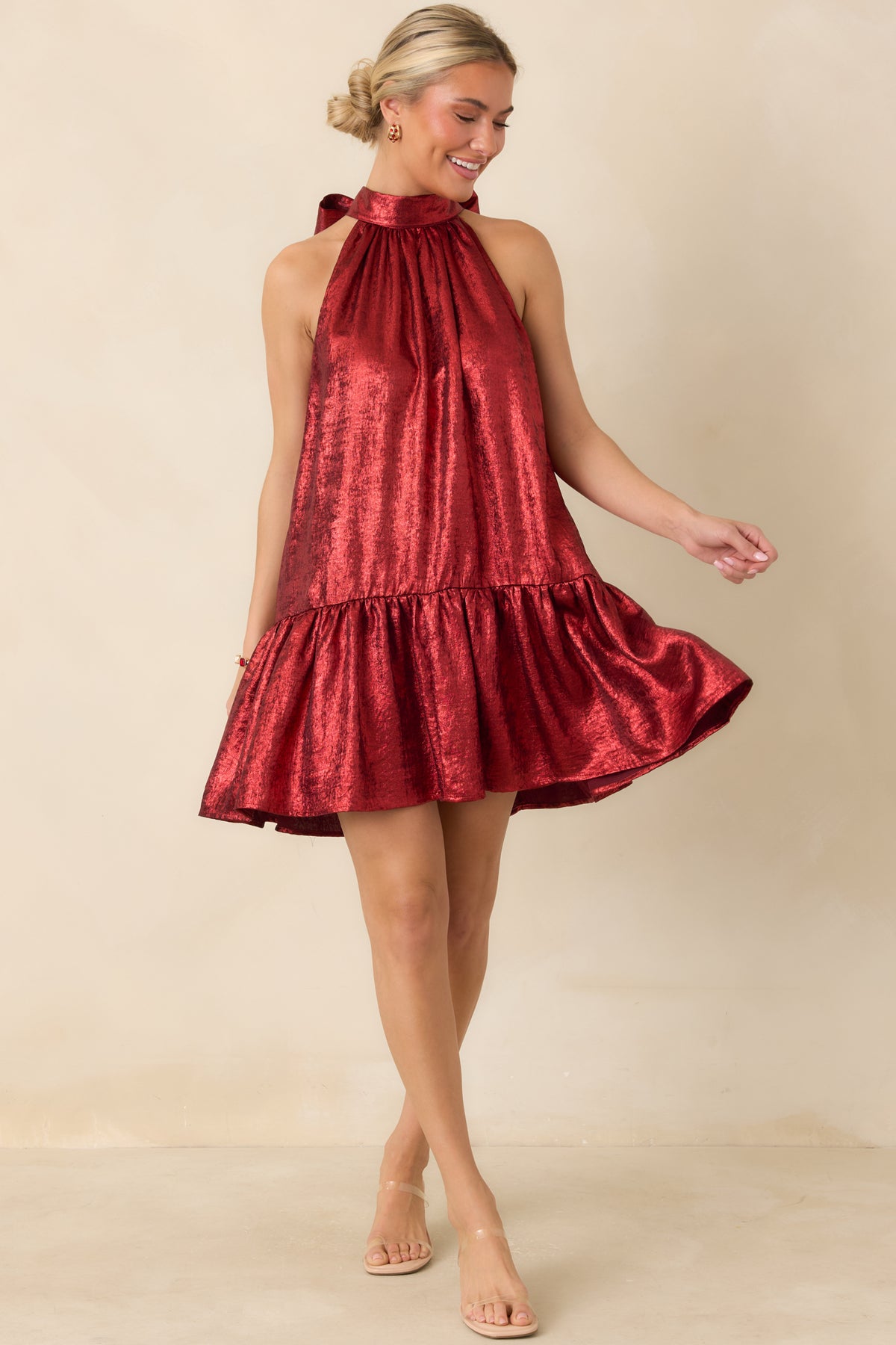Rich red mini dress with a draped halter neckline, flared skirt, and glossy fabric finish.