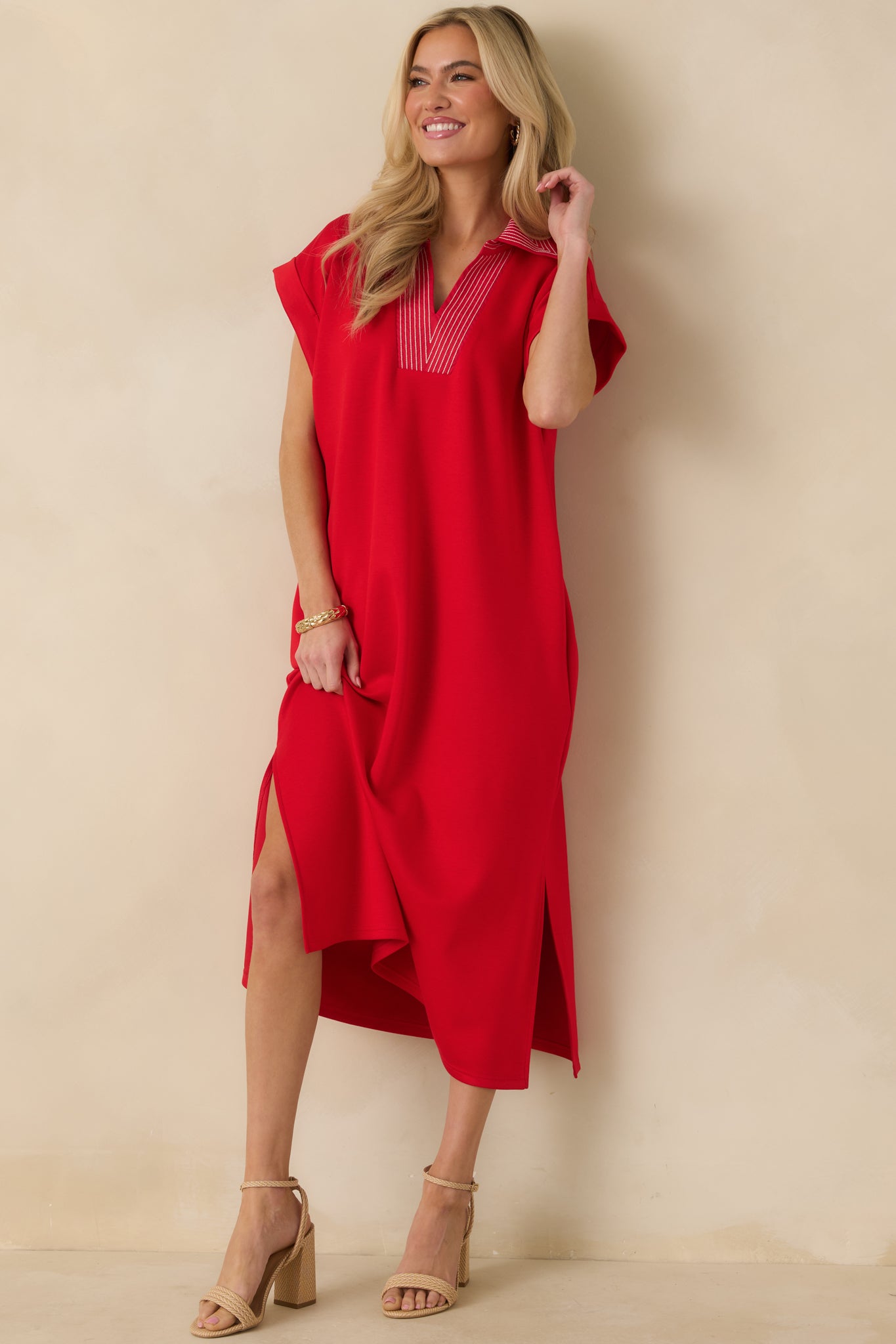 Red knit midi dress with a straight-cut silhouette, V-neckline, and side slit detailing.