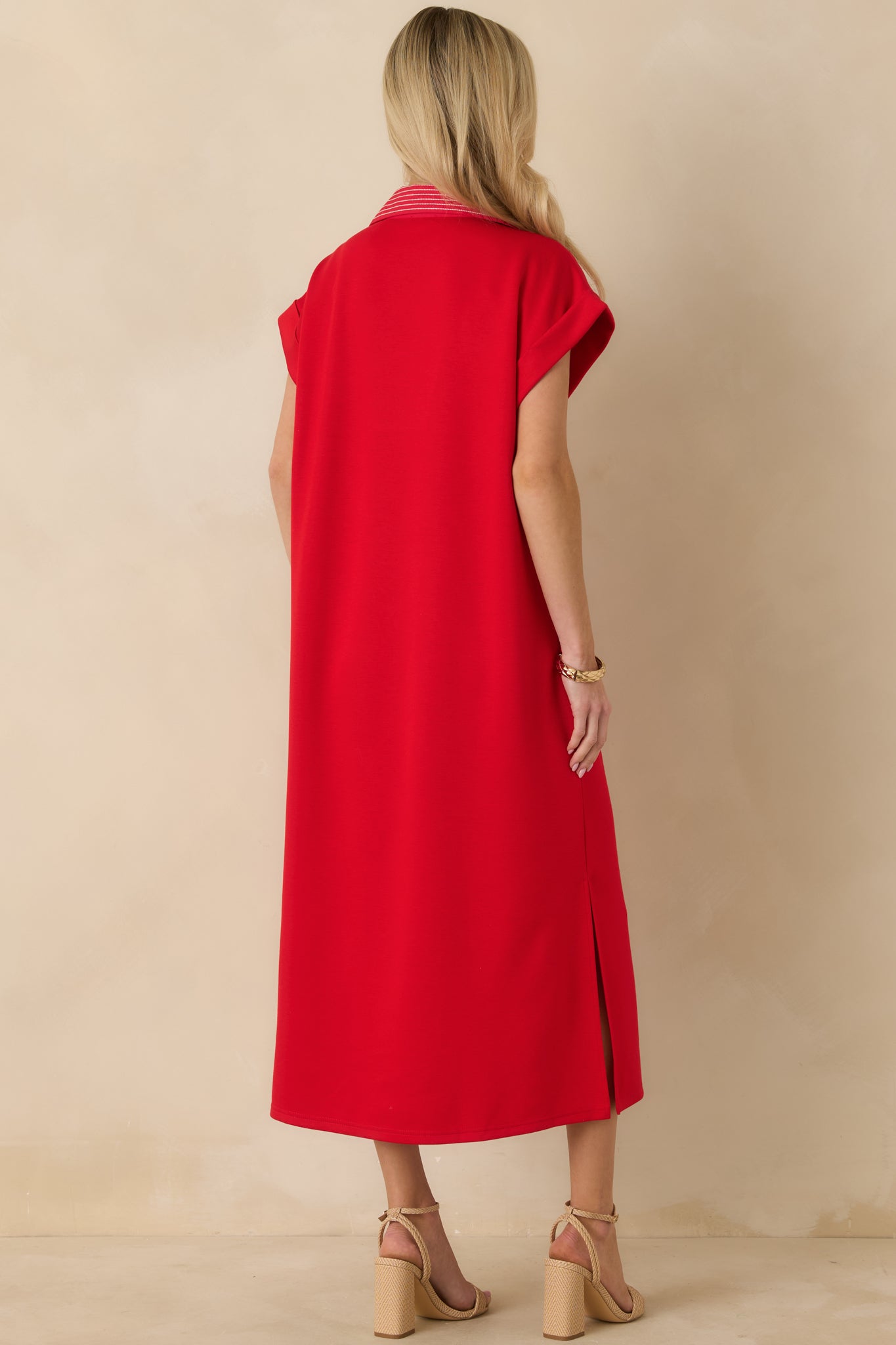 Red knit midi dress showing a straight silhouette, short sleeves, and a clean rear hemline.