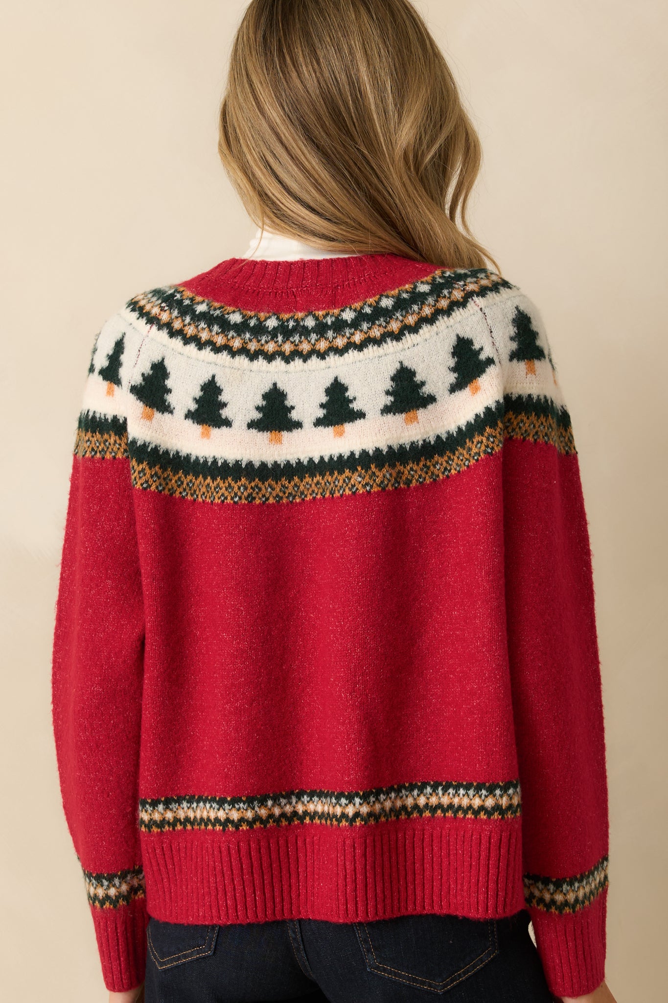 Rear view of red knit sweater showing clean back design and ribbed trim finish.