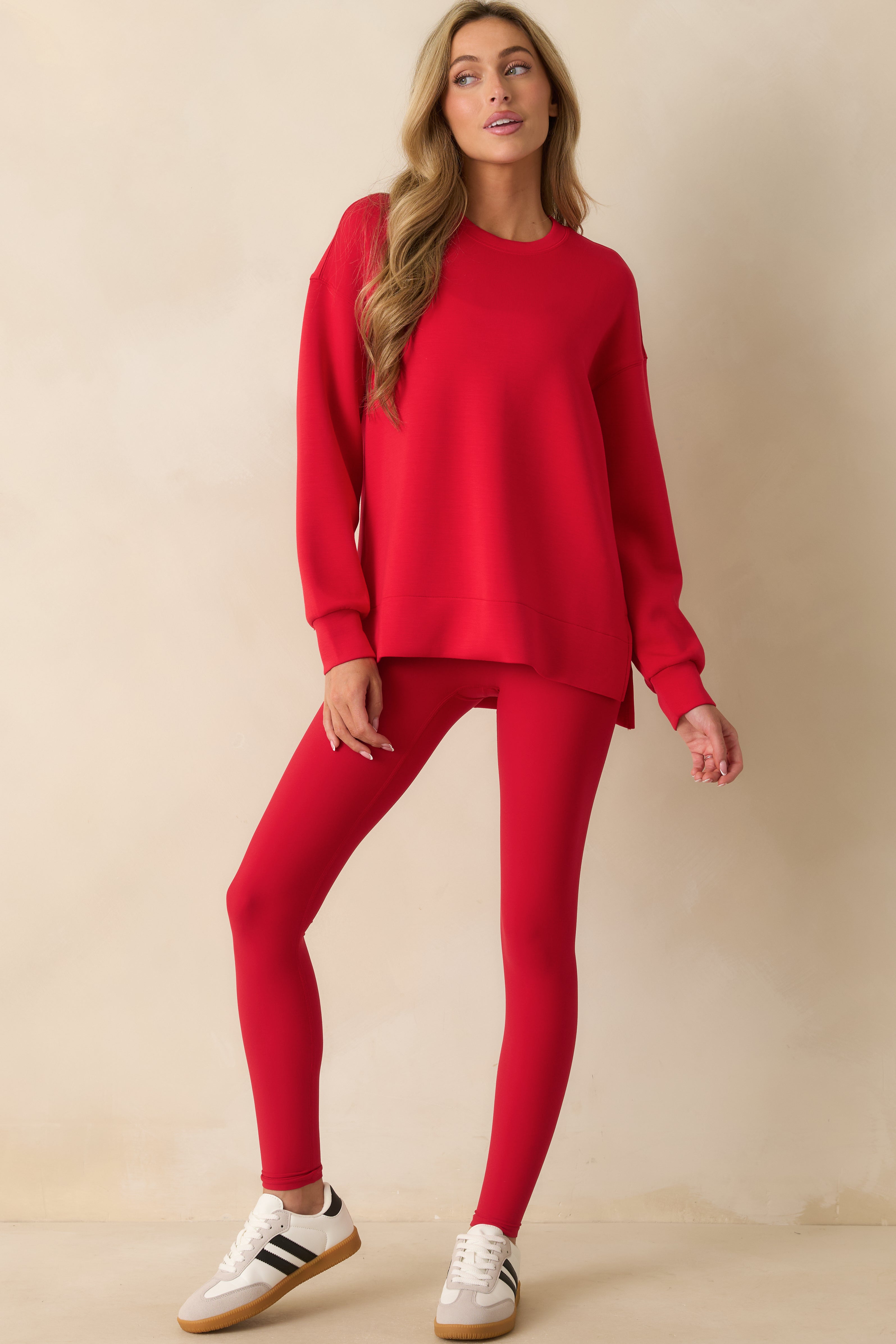 Full-length red leggings with a high-rise waistband and smooth, sweat-wicking performance fabric.