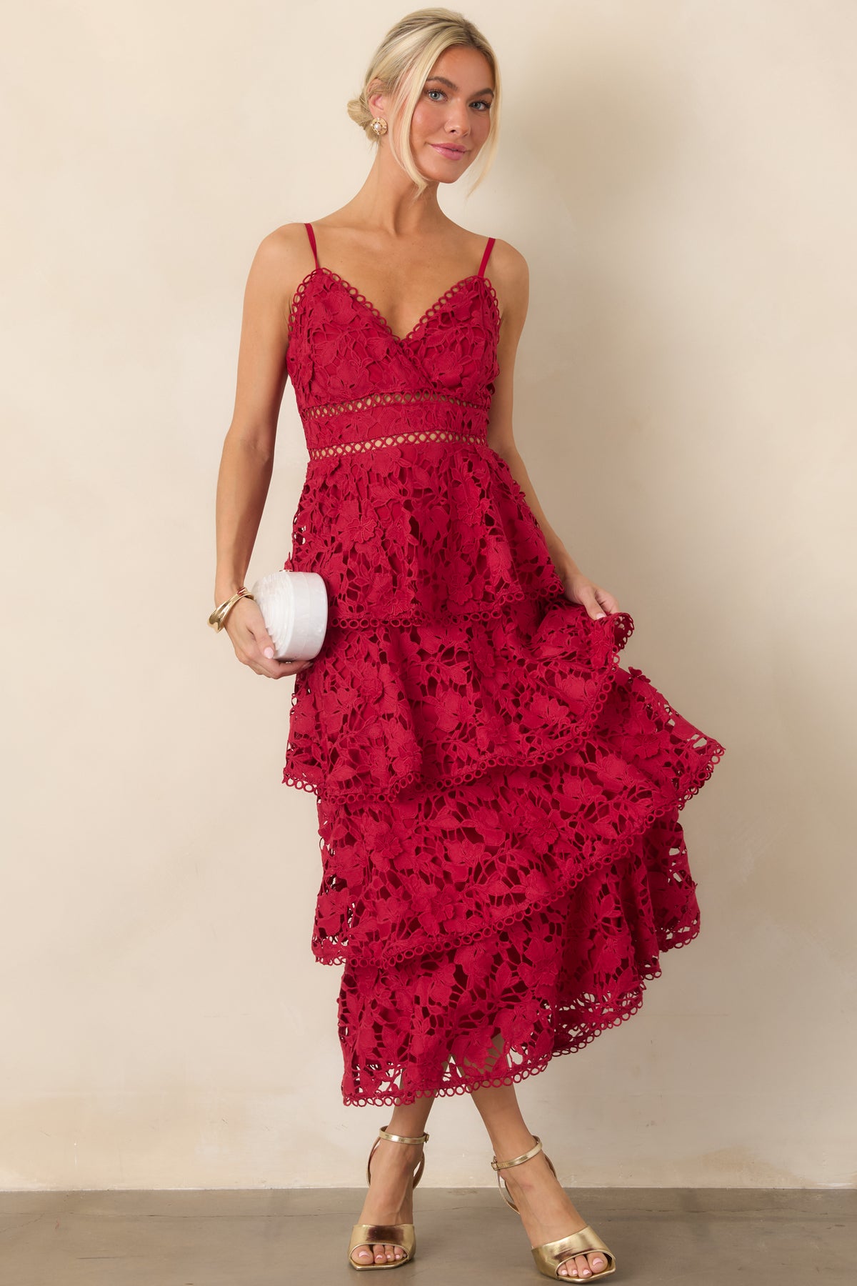 Red maxi dress showcasing its flowing tiered lace silhouette, V-neckline, delicate spaghetti straps, and open waist detailing.