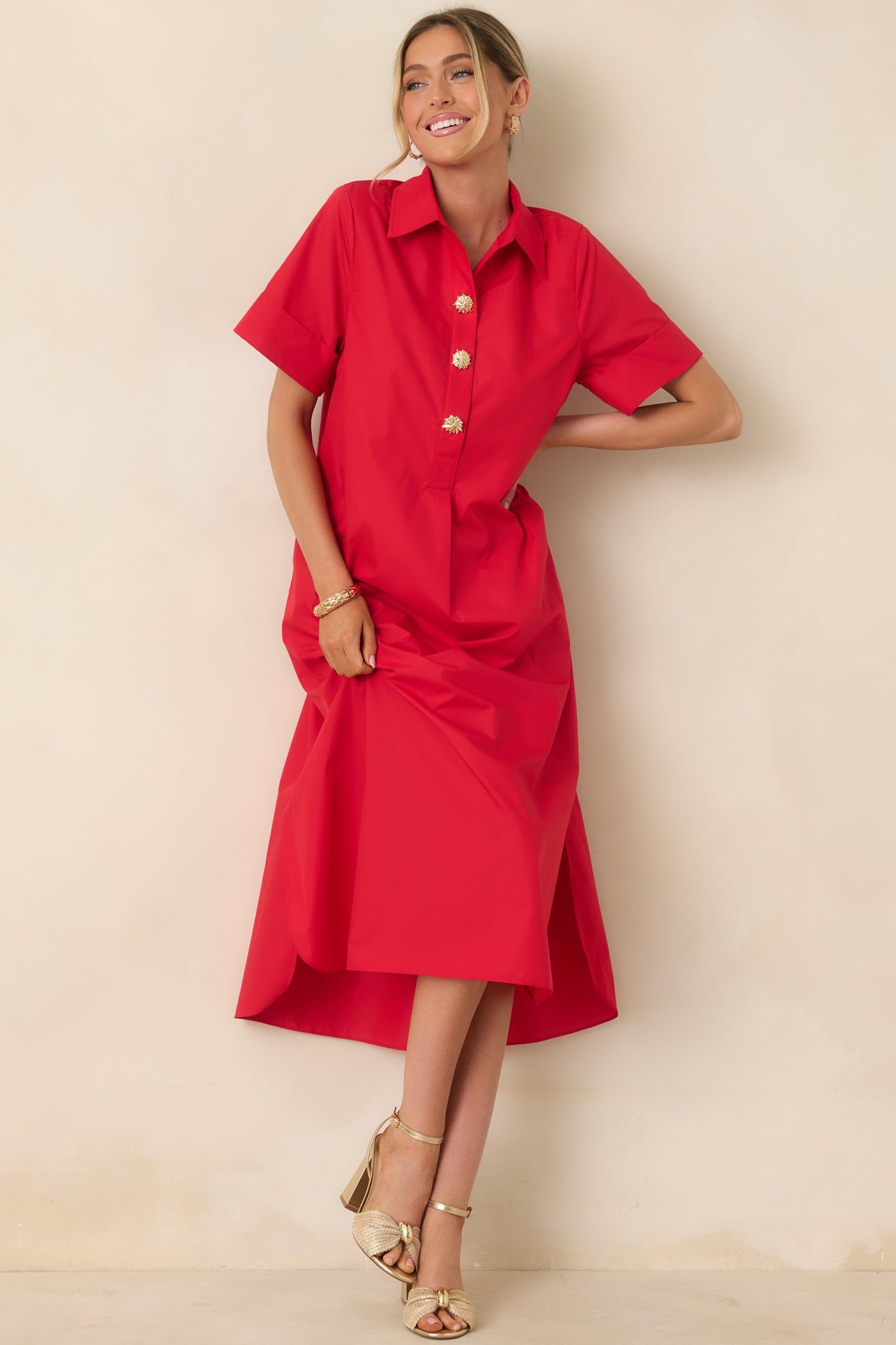 Red maxi dress with collared neckline and gold snap button front.