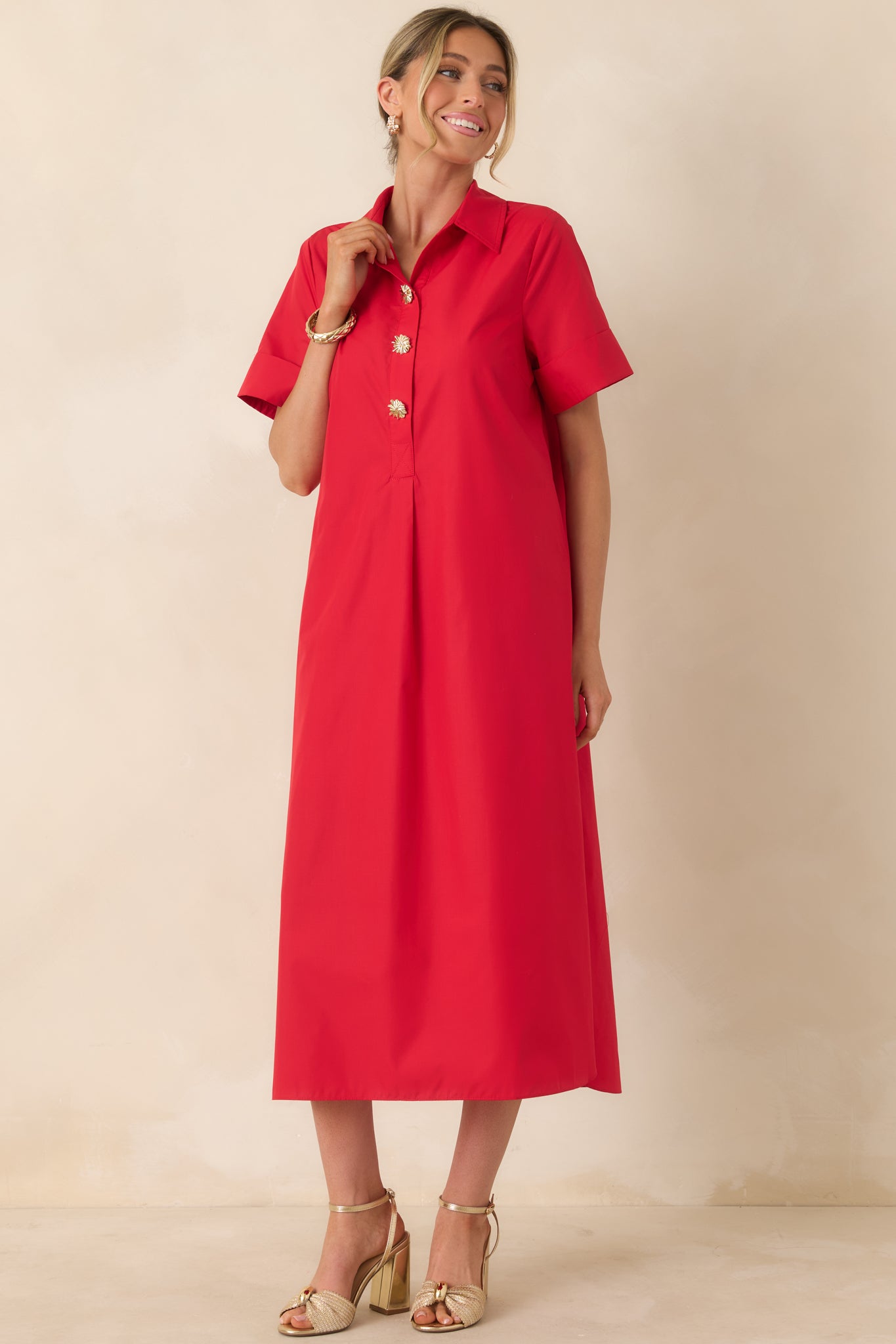 Red maxi dress with collared neckline and practical pocket detail.