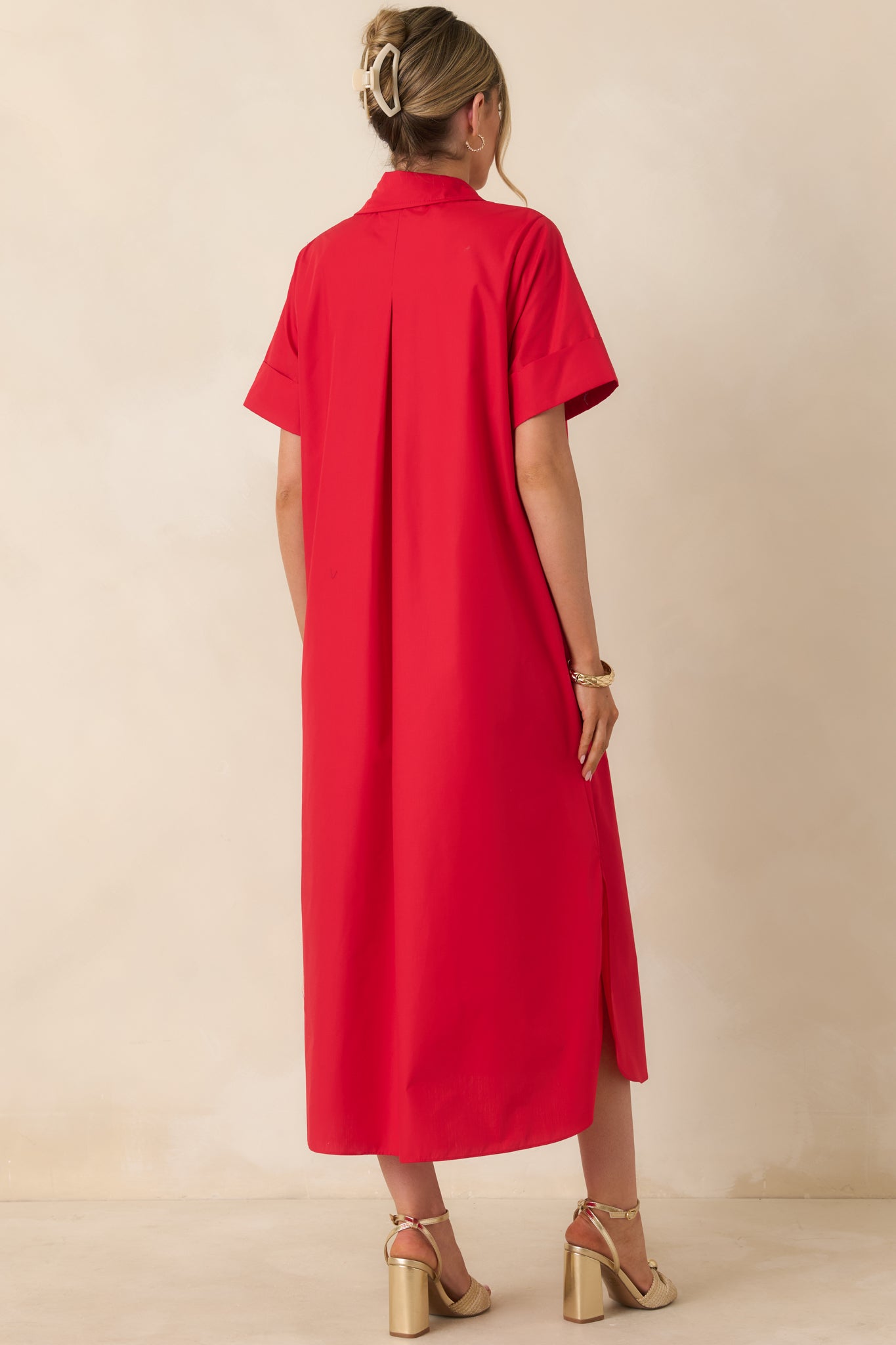 Red maxi dress with flowing silhouette and structured collar from rear.