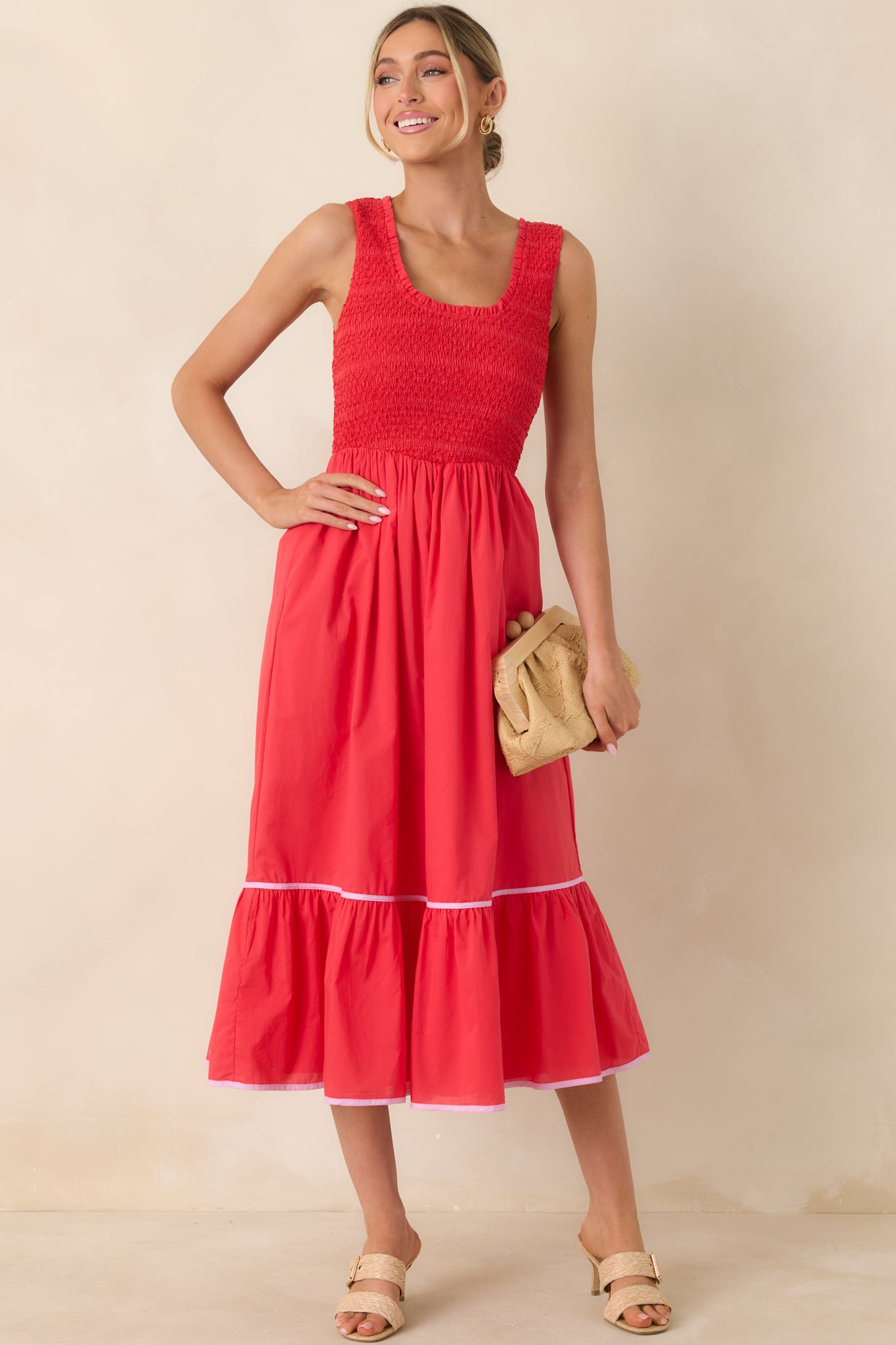 Textured red midi dress with a fitted smocked bodice and airy skirt finished with a subtle ruffle hem.