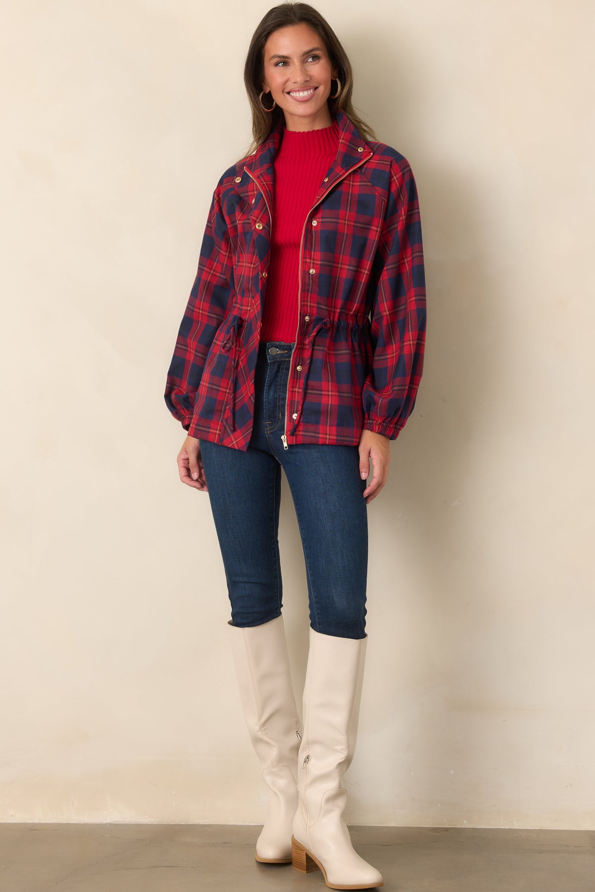 Rich red and navy plaid jacket with long sleeves, an adjustable drawstring waist, and oversized utility pockets.