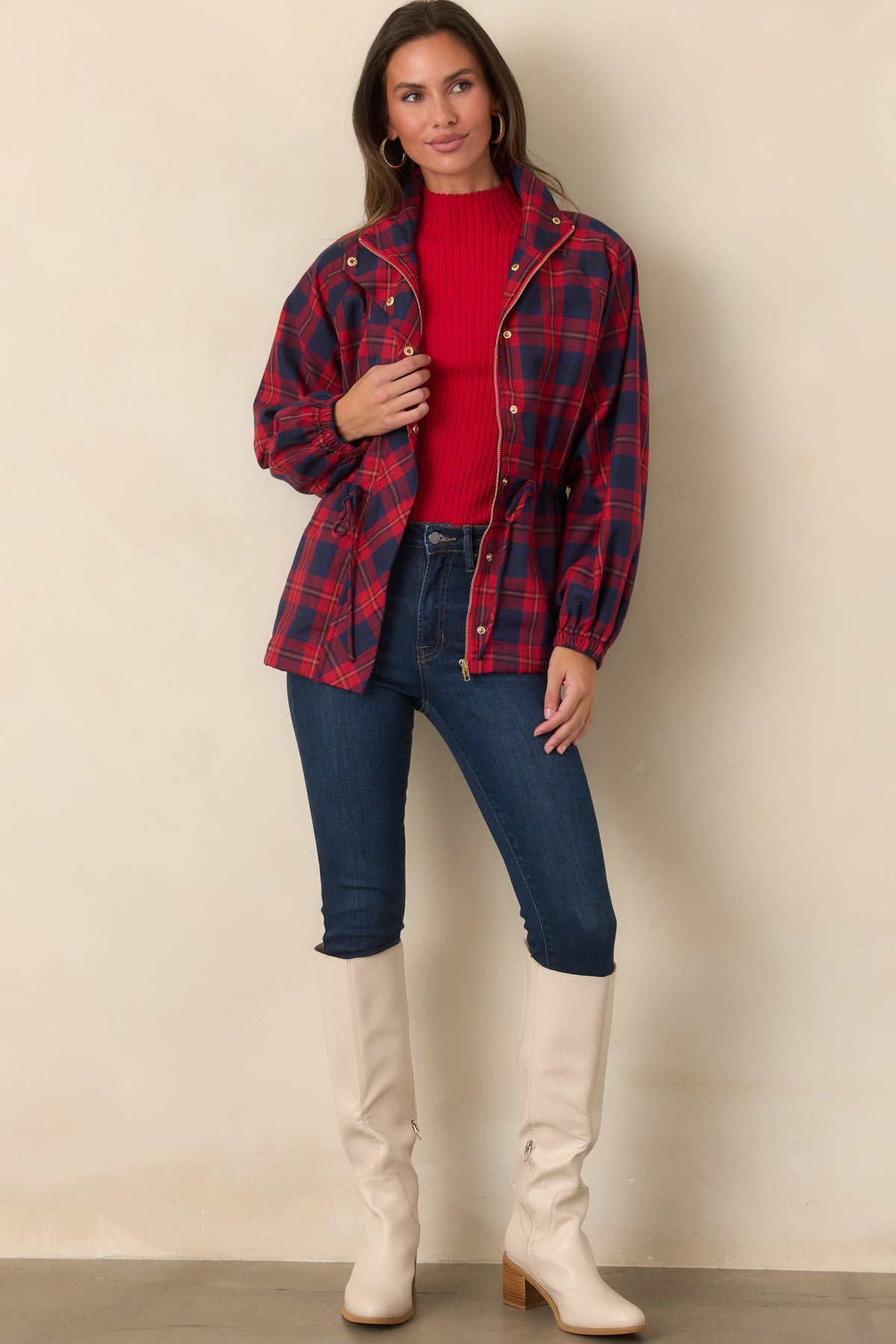 Red and navy plaid jacket designed with a lightweight construction, oversized patch pockets, and adjustable waist.