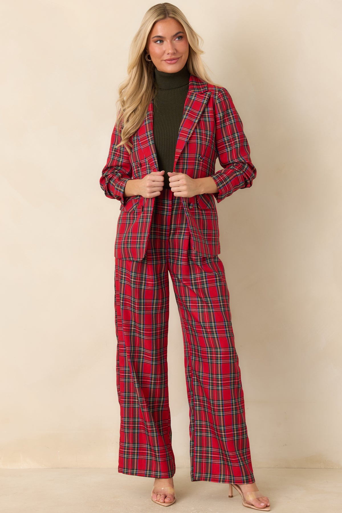 Red plaid blazer with notched lapels, a button-front closure, and functional front pockets.