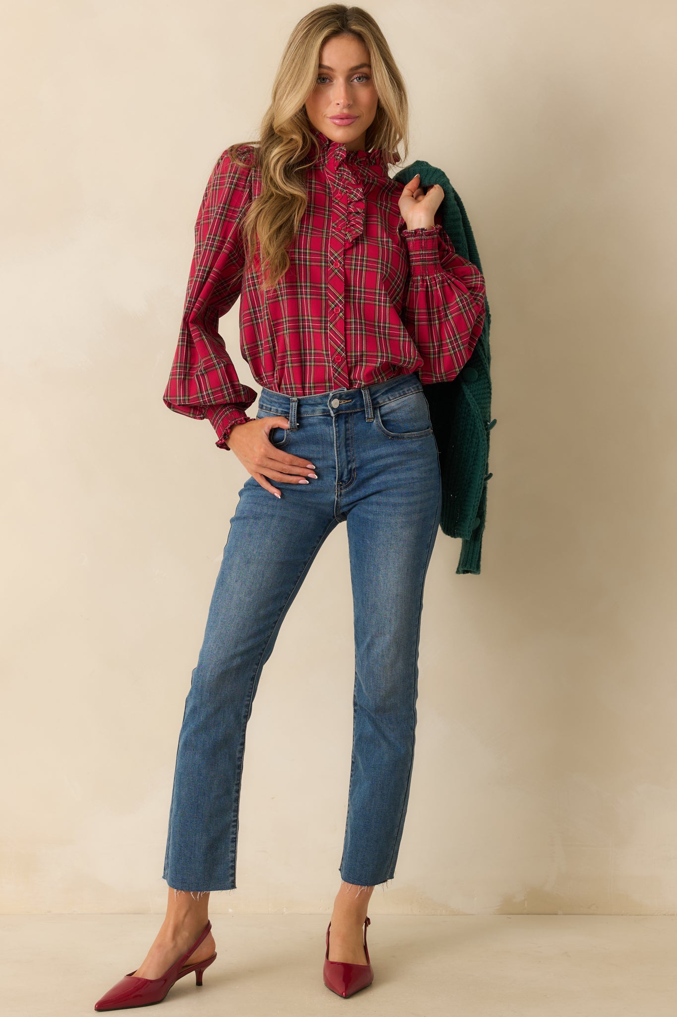 Red plaid blouse with long puff sleeves, smocked cuffs, and ruffle neckline, showcasing the classic check pattern and tailored fit.