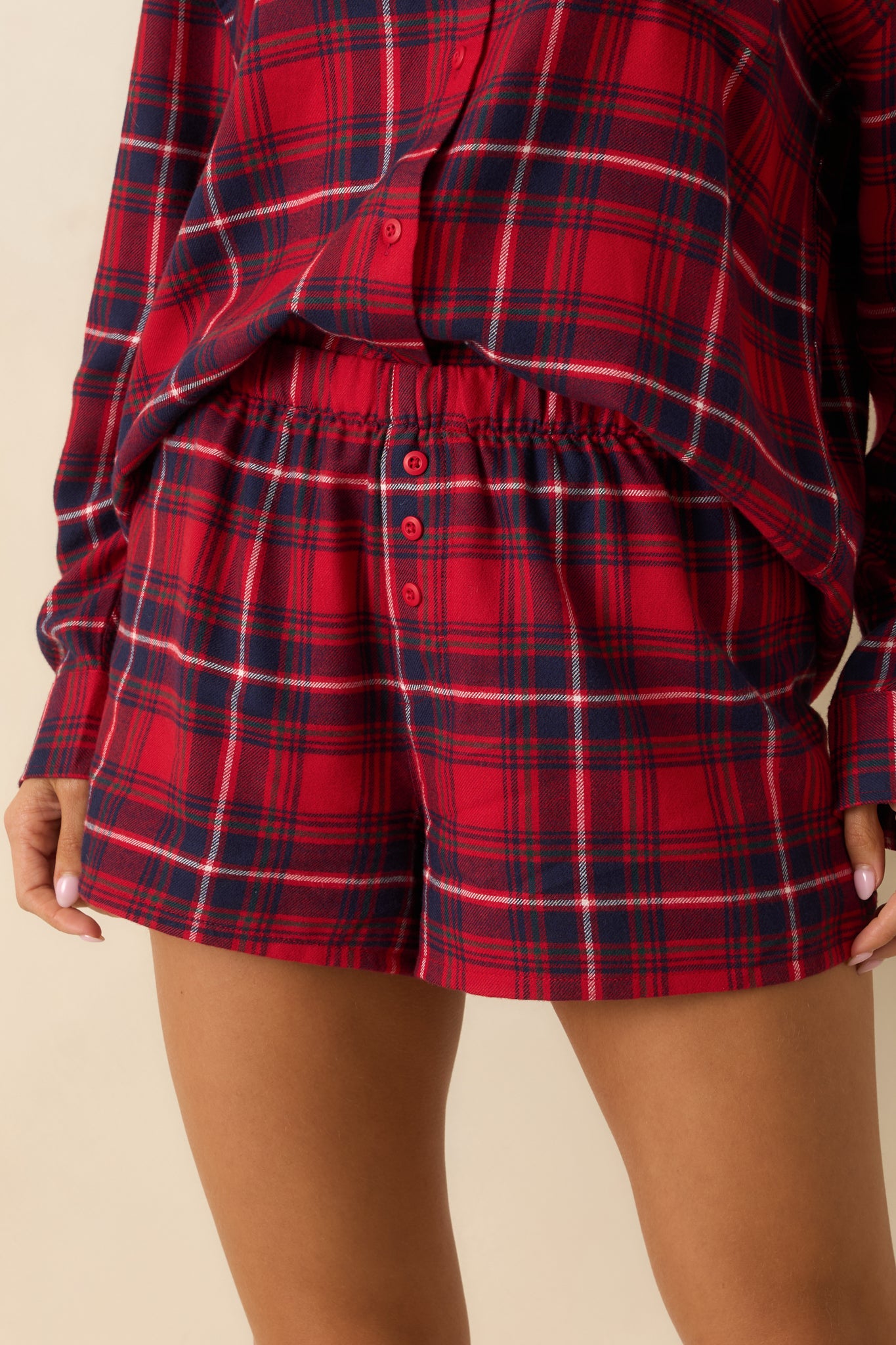 Lightweight flannel fabric in red plaid, showing faux button-front placket and soft texture.