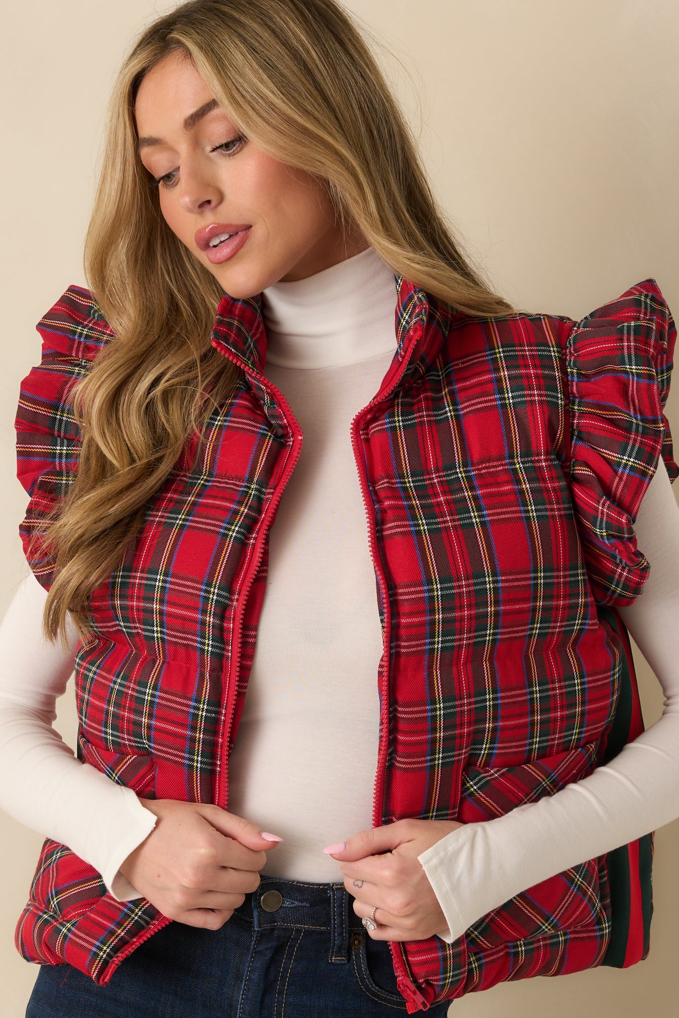 Red plaid puffer vest showing the plaid pattern and lightweight padding.