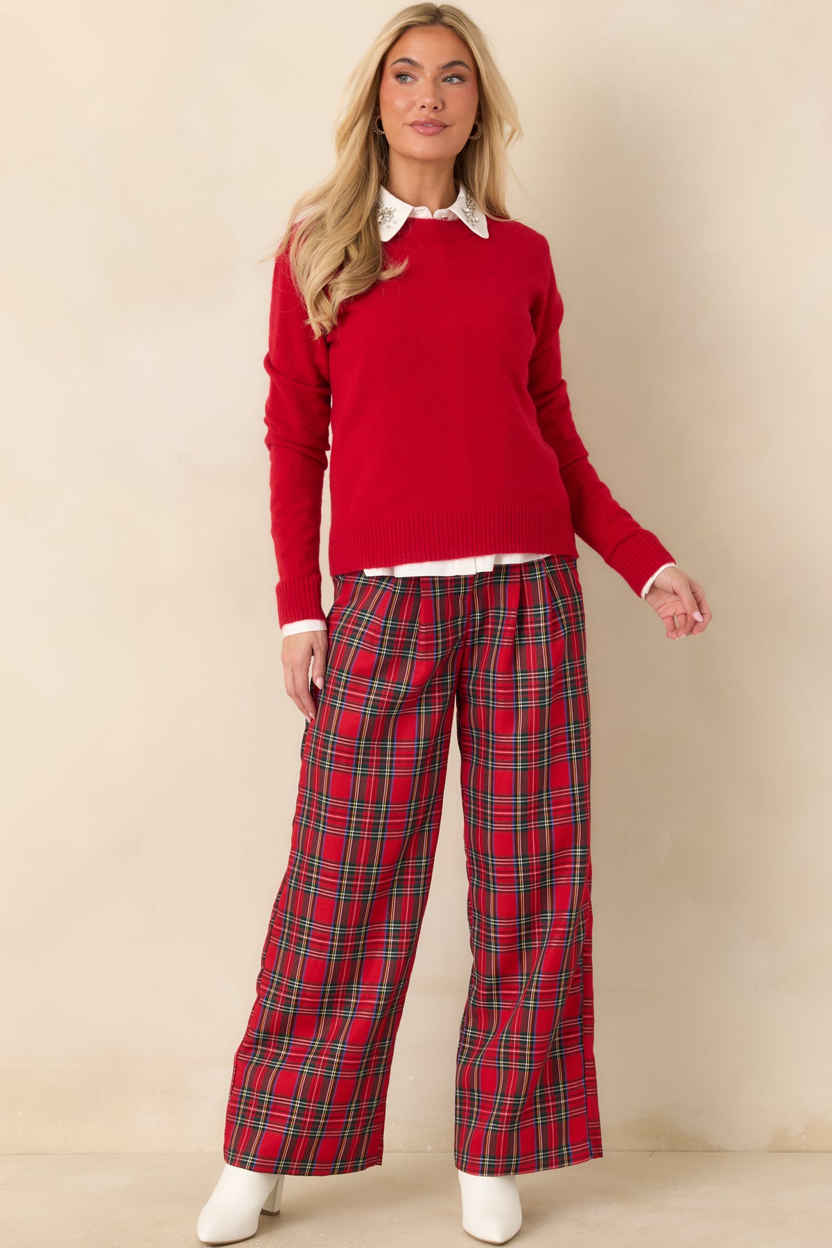 Red plaid wide-leg trousers featuring a tailored high-rise waist and classic pleated front.
