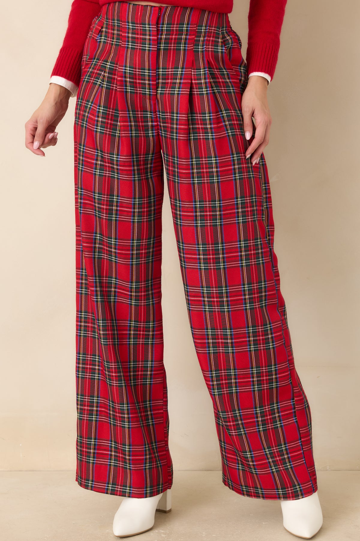 Red plaid trousers featuring functional side pockets and a structured high-waisted fit.
