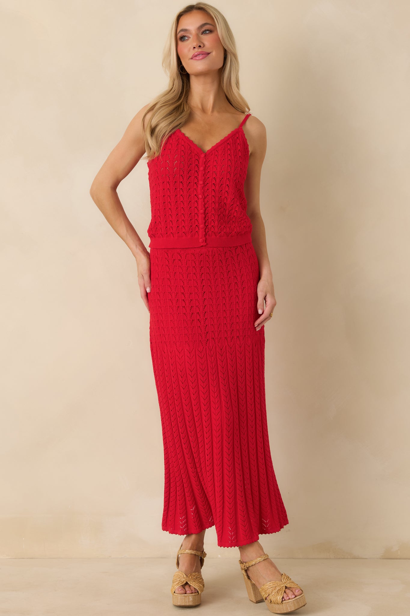 Red pointelle sweater tank designed with breathable knit fabric and clean, streamlined lines.