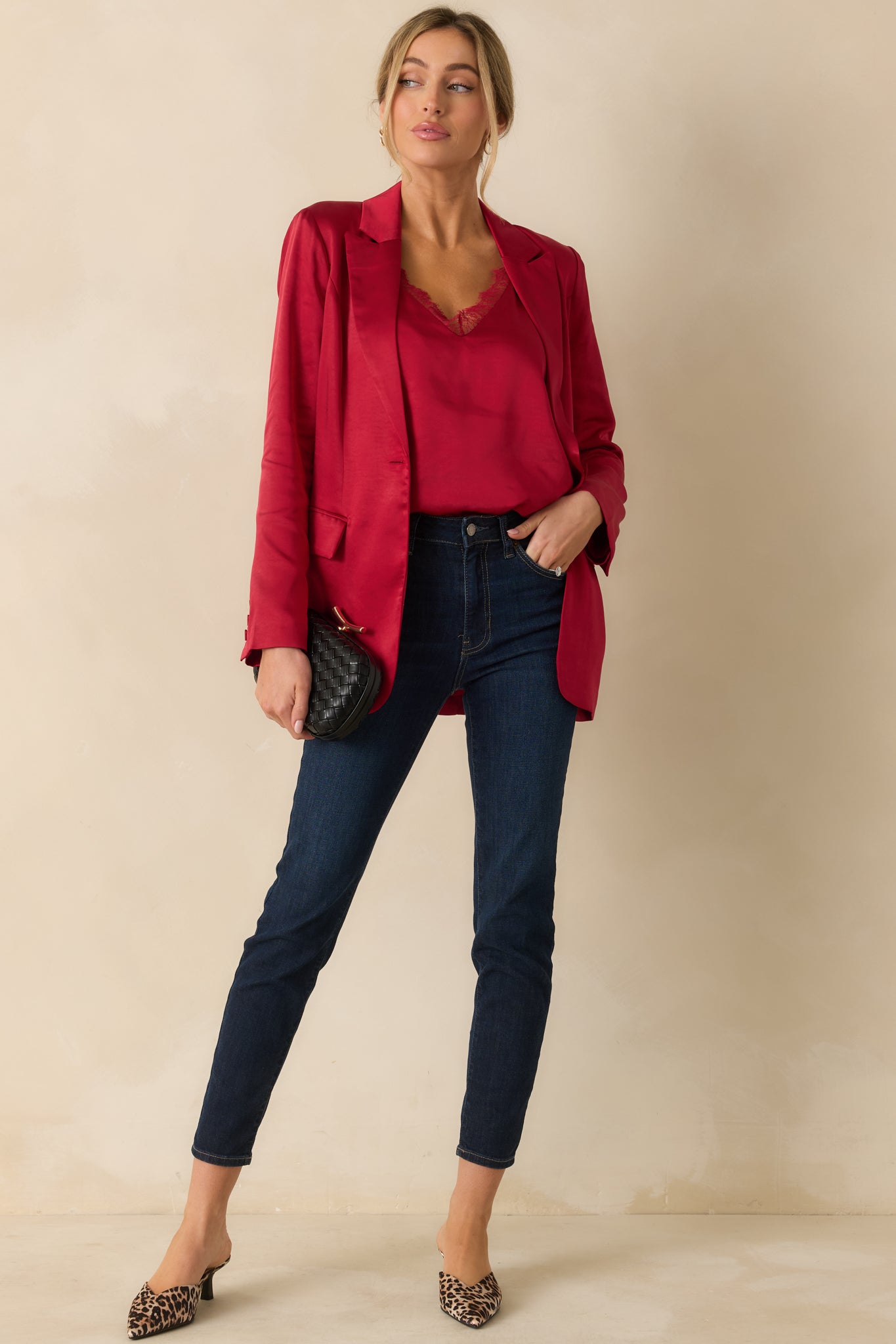 Sleek red cami featuring a subtle sheen, straight hem, and delicate lace-trim adjustable straps for a polished look.