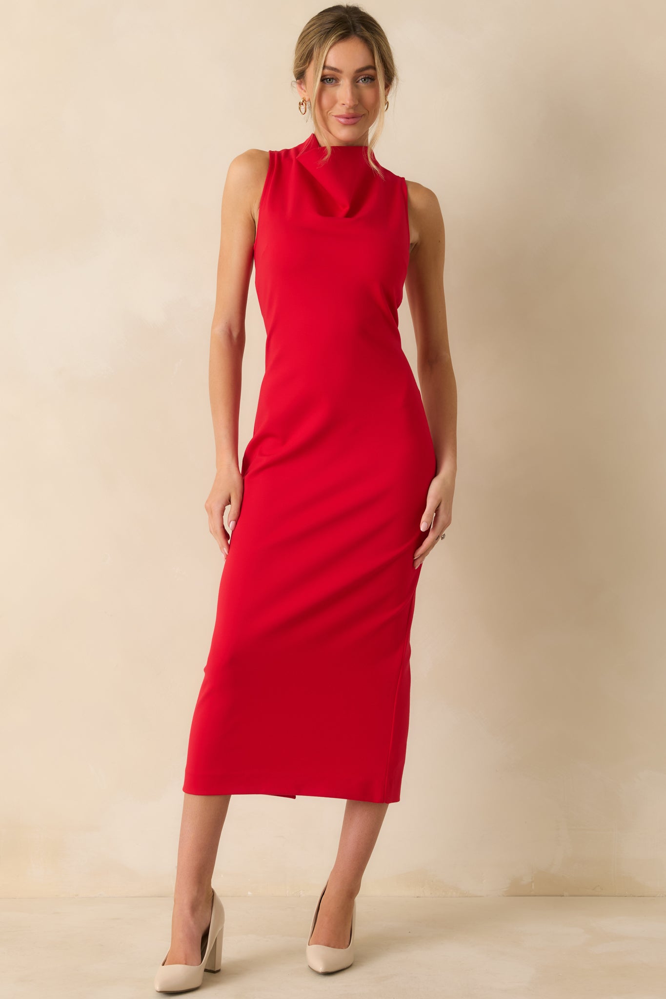 Figure-enhancing red sleeveless dress with a bodycon silhouette and high neckline, inspired by SPANX® design for flattering shape.