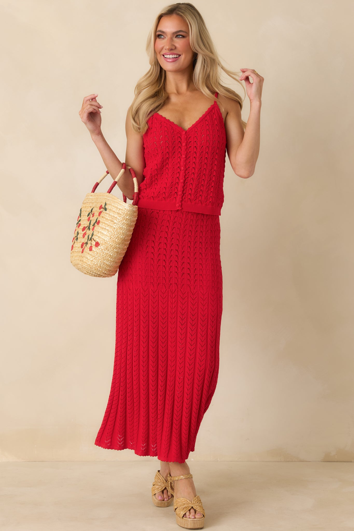 Red sweater tank with a fitted silhouette, adjustable shoulder straps, and a ribbed hem for a flattering finish.