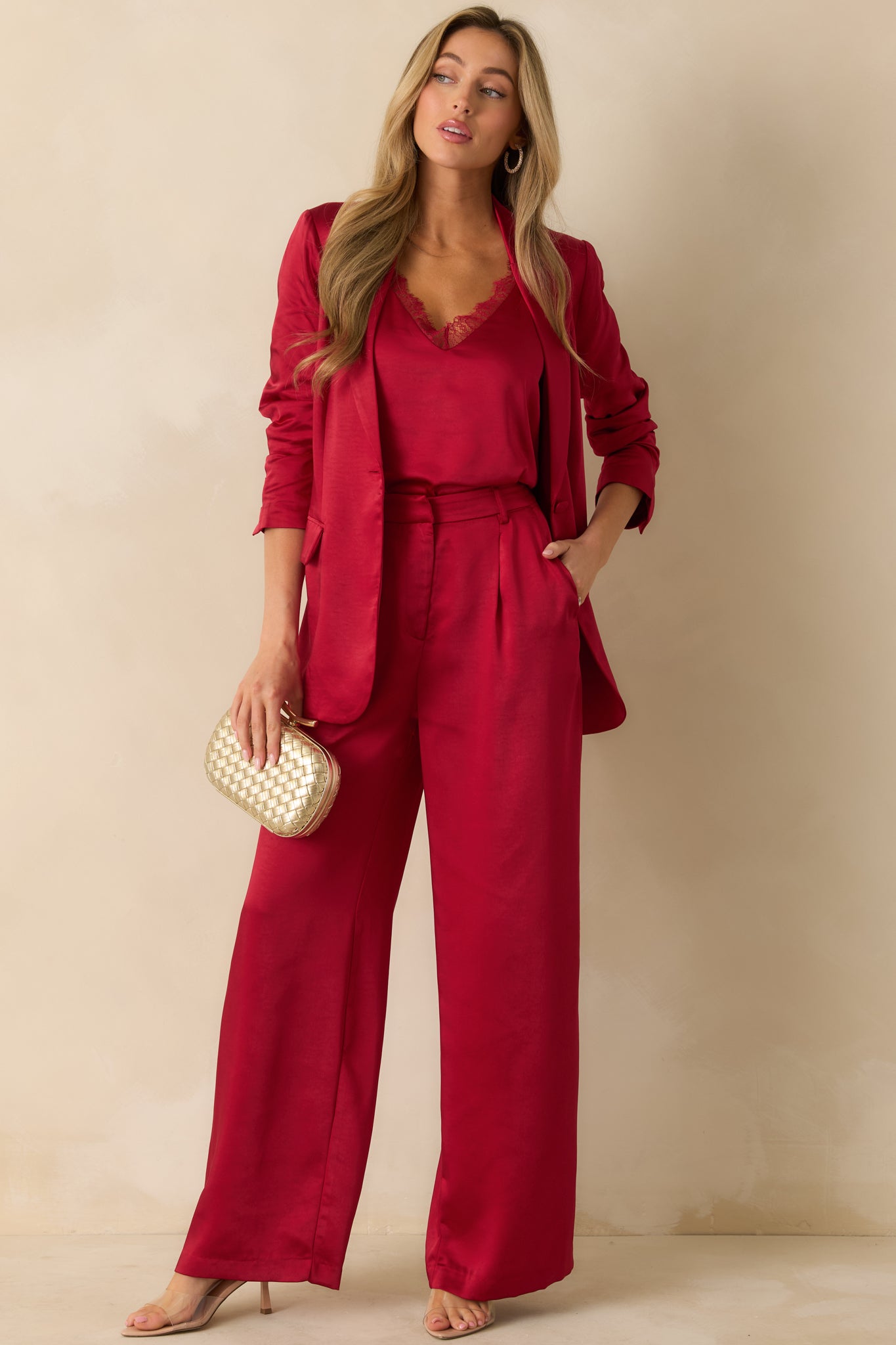 Sleek red blazer featuring long sleeves with buttoned cuffs, lightly structured fit, and polished single-button front closure.