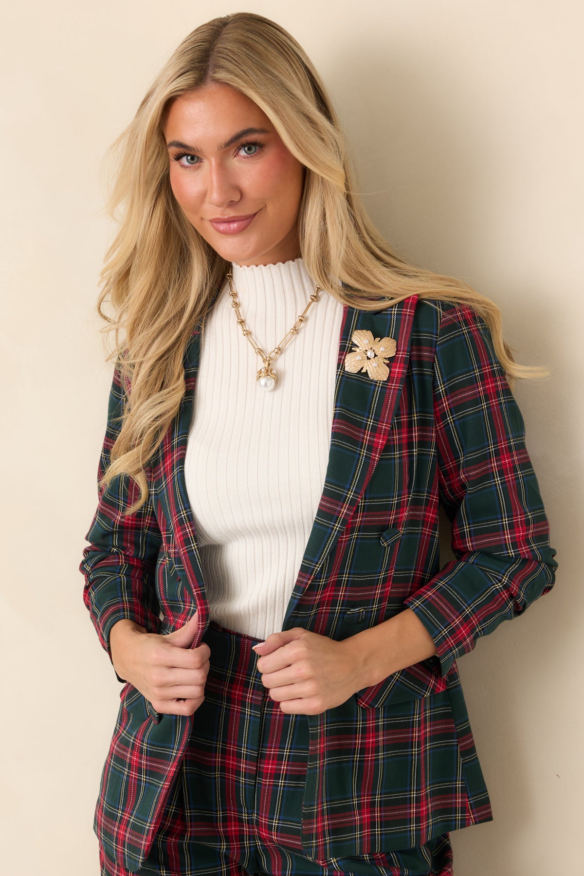 Red tartan blazer with long sleeves gathered and stitched at the inner elbows for a softly scrunched finish.