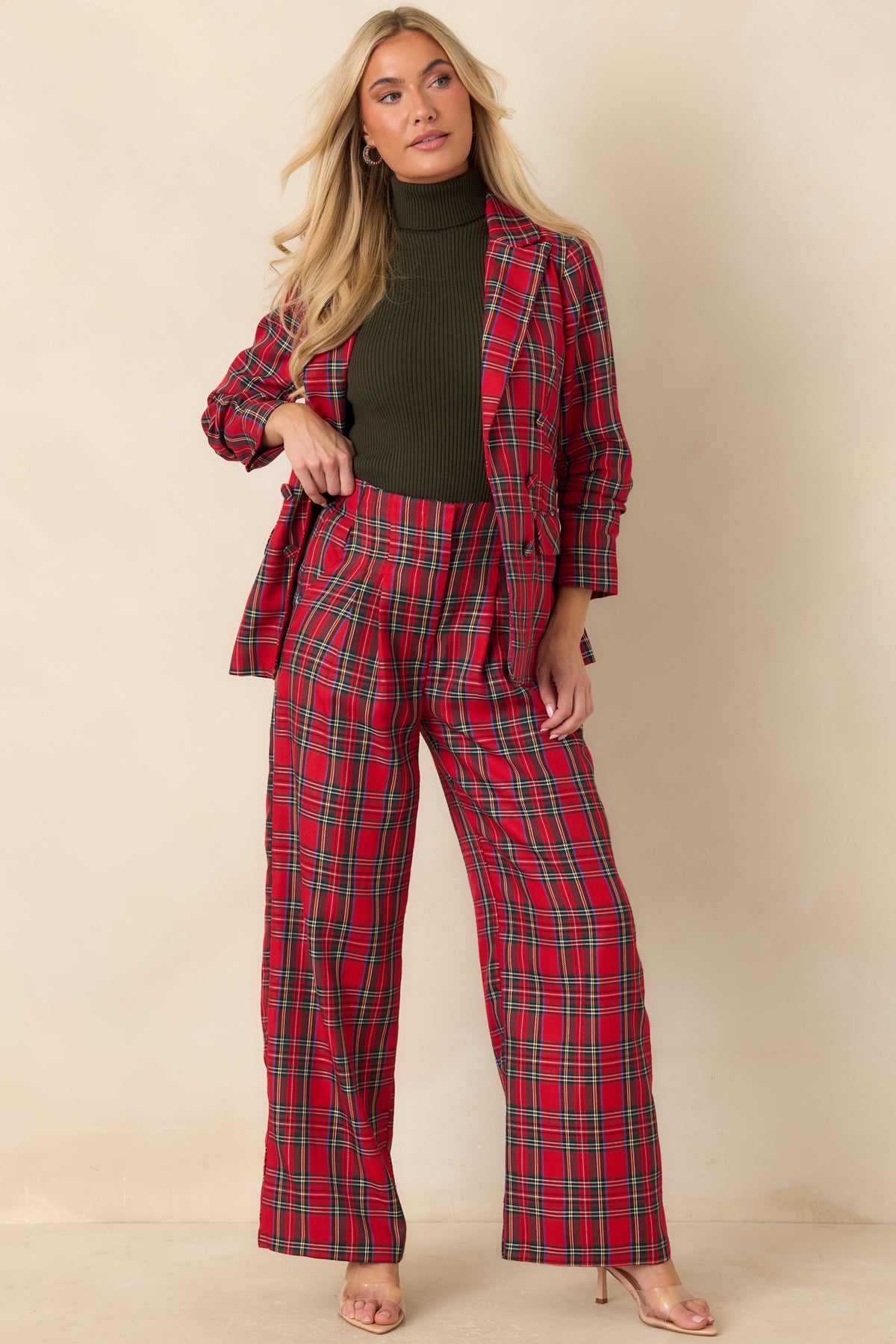Red tartan plaid pants with a high-rise waistband and neatly tailored front pleats.