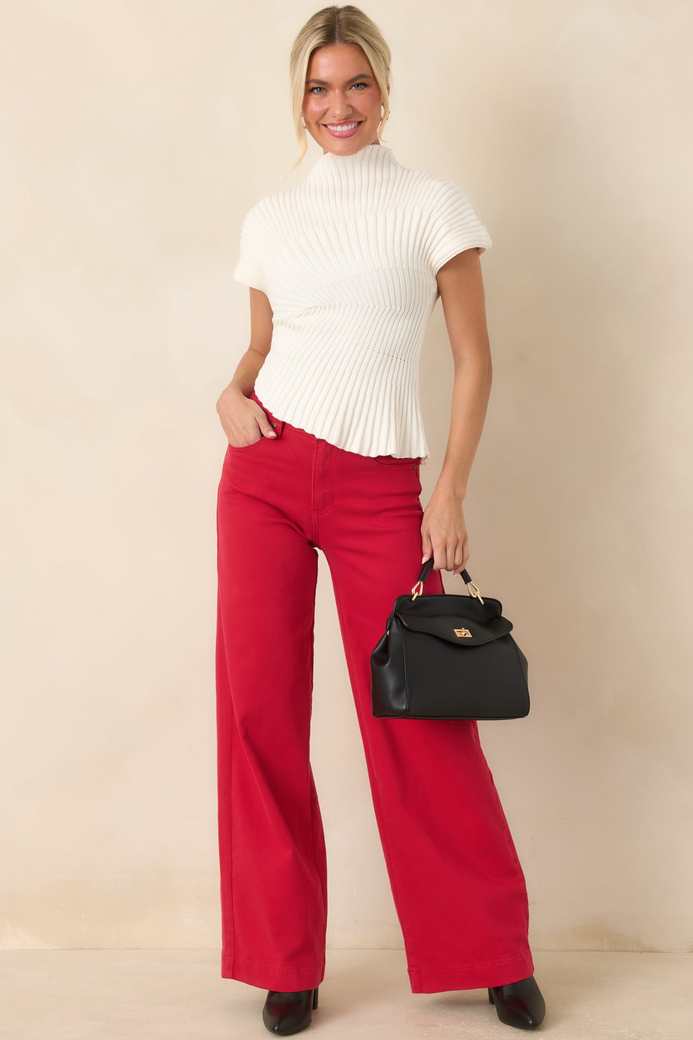 Vibrant red wide leg jeans featuring a high-rise waist, button-and-zip closure, belt loops, and full-length silhouette.