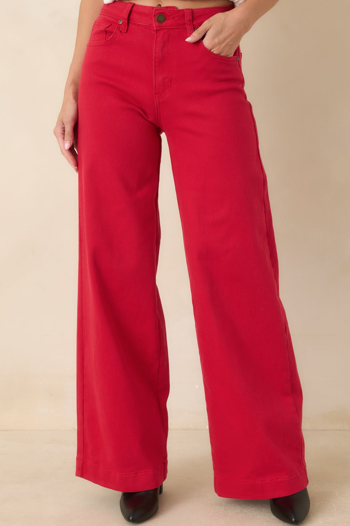 Red wide leg jeans showcasing the fitted upper silhouette, clean seam detailing, and full-length leg design.