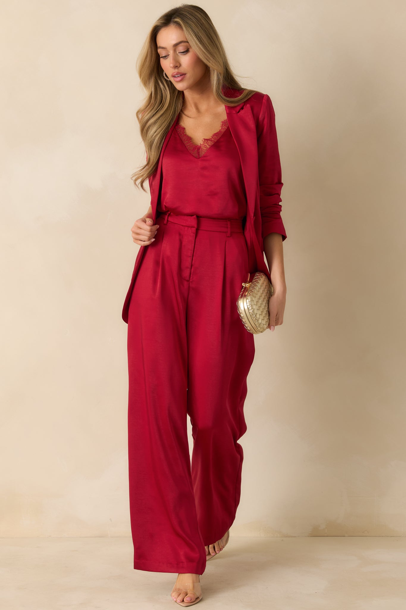 Tailored red wide-leg pants with pleated detailing, side pockets, and a high-rise waist for a polished look.