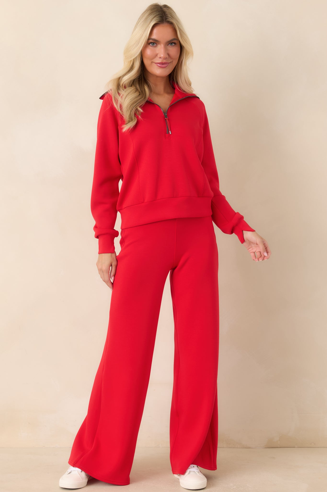 Vibrant red wide-leg pants featuring a smooth pull-on waistband, adjustable drawstring, and fluid full-length silhouette.