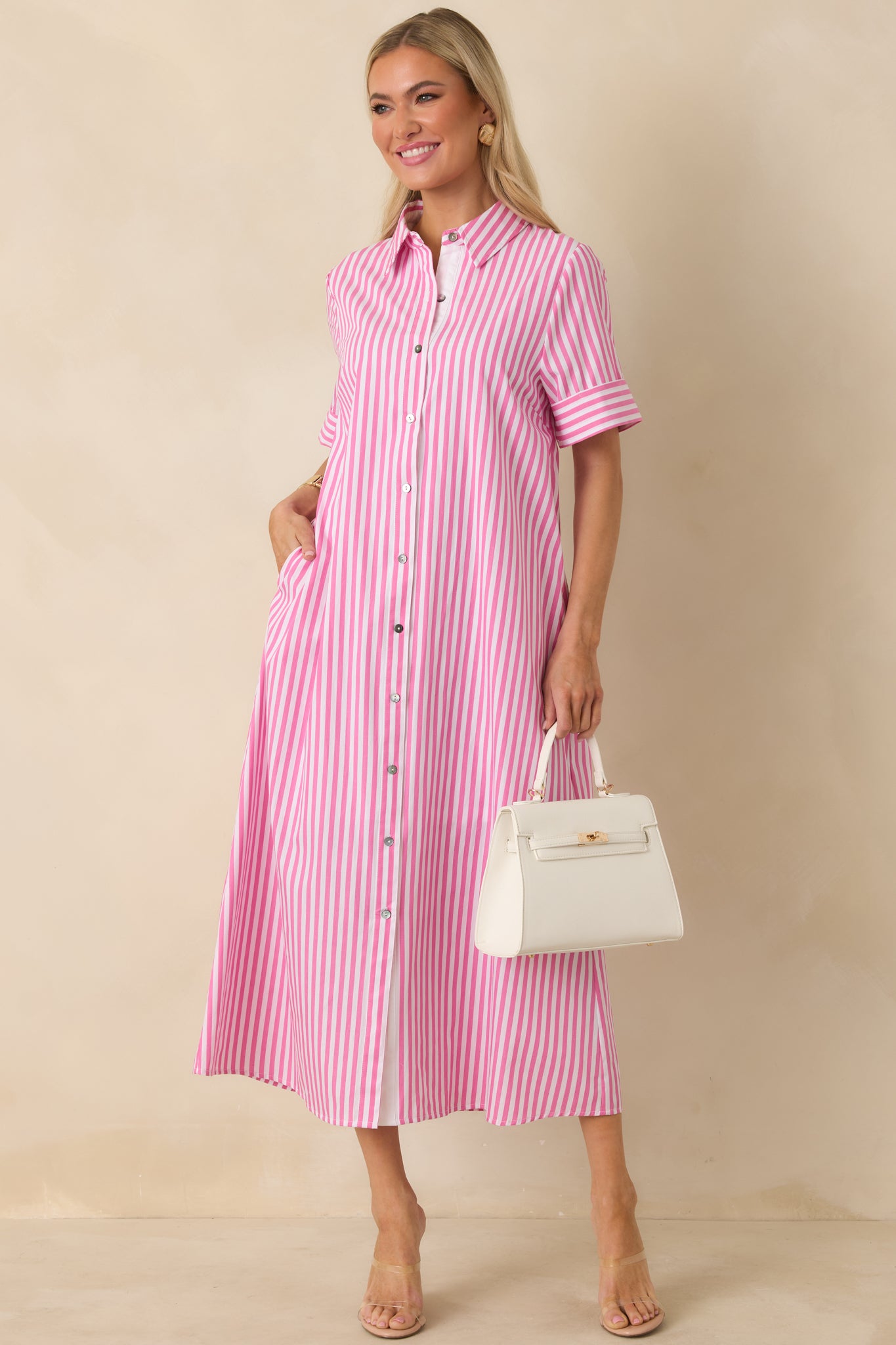 Relaxed A-line maxi dress featuring soft stripes, cuffed sleeves, and flowing hemline.