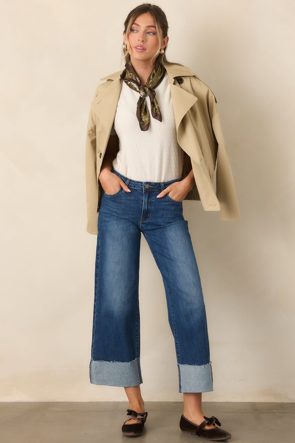 Relaxed beige trench jacket featuring a drop-shoulder silhouette, double-breasted closure, and elasticized waist.