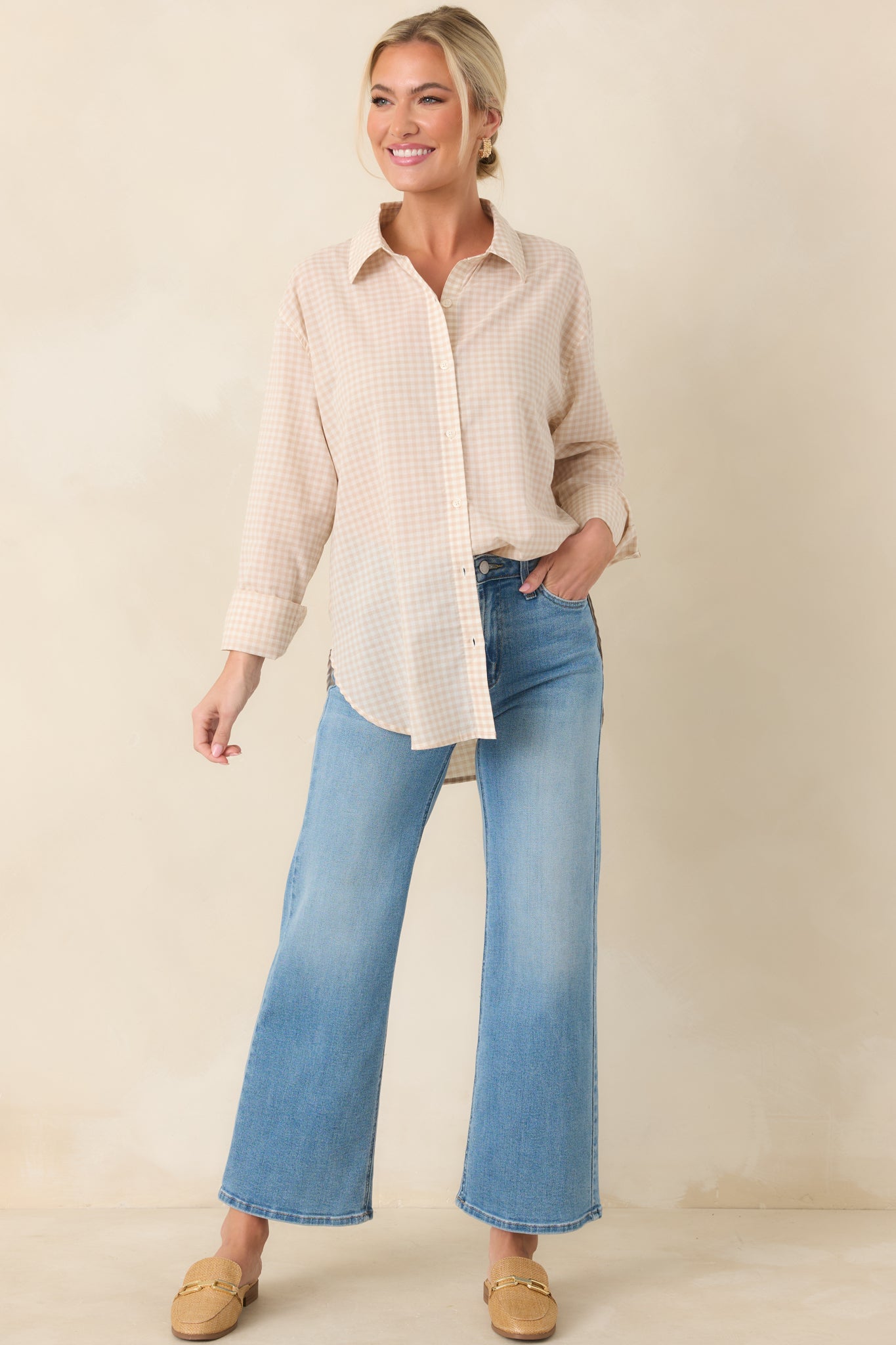 Relaxed beige gingham shirt featuring a collared neckline, rolled sleeves, and a slightly curved hem.