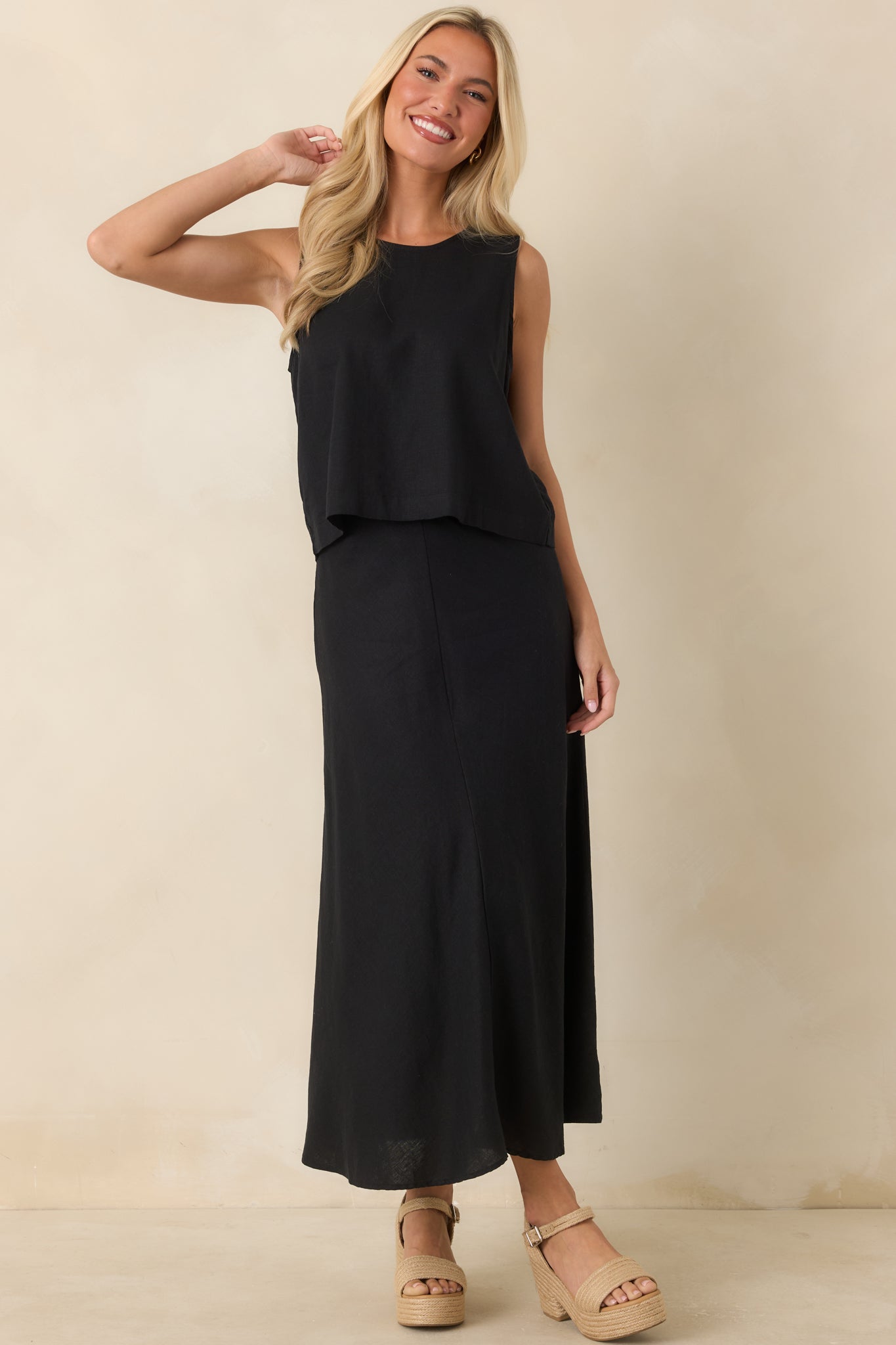Relaxed black linen top showcasing a clean neckline and effortless everyday style.